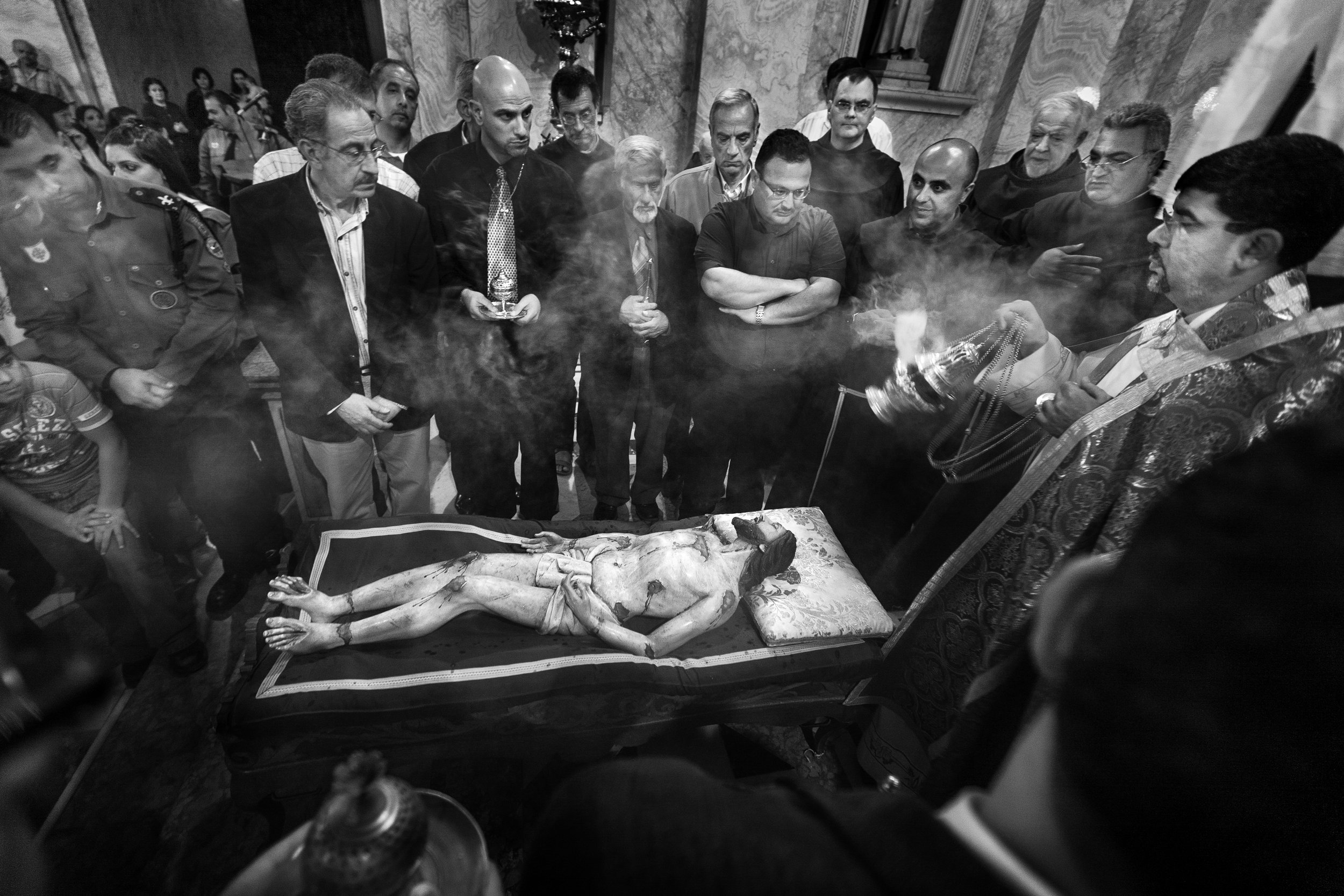  Worshippers touch the body of Christ during the funeral procession as part of their Easter mass at the Saviors Catholic Church in the Old City of Jerusalem. 