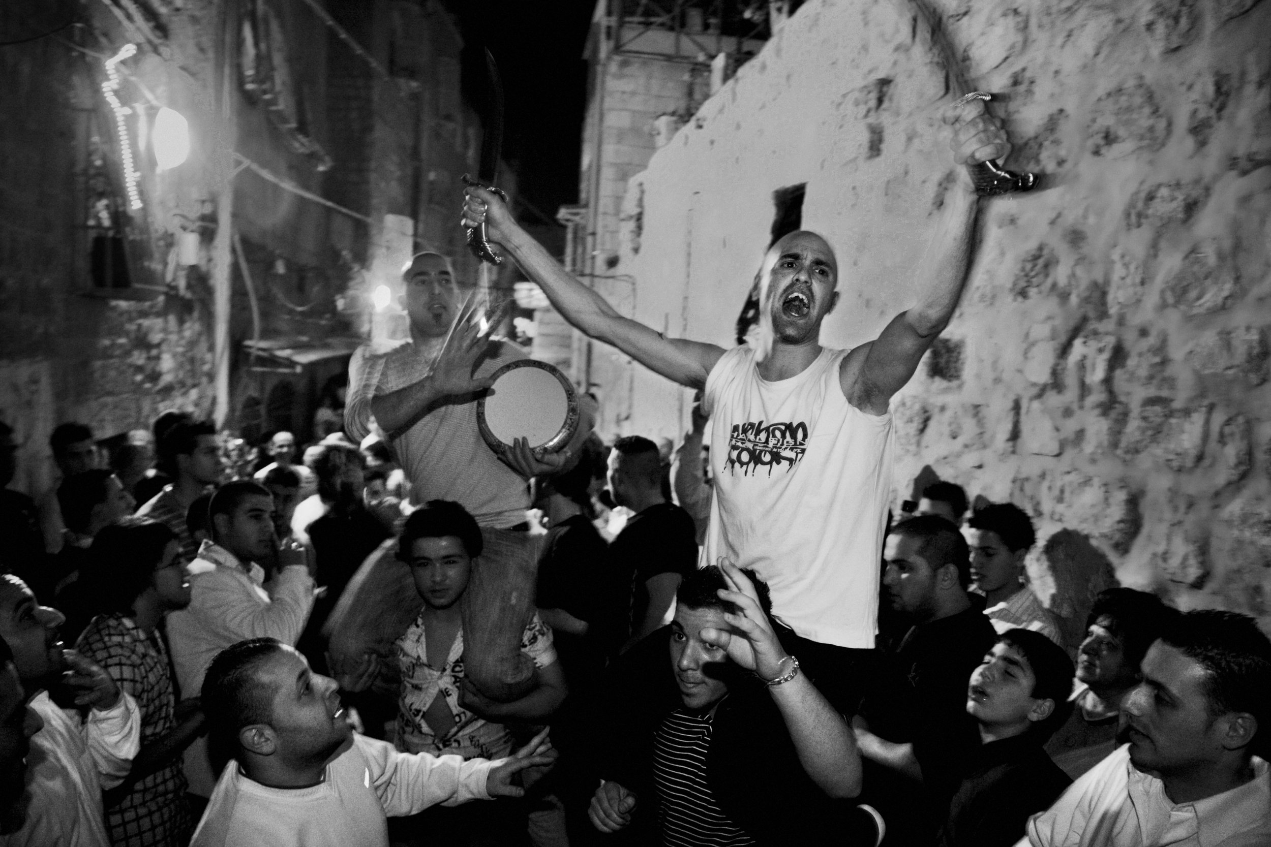  Palestinian Catholics celebrate their faith in the streets in the Old City of Jerusalem on March 22, 2008. The worshippers are celebrating Catholic Easter with a procession that is led by Arab Catholic Scouts. 