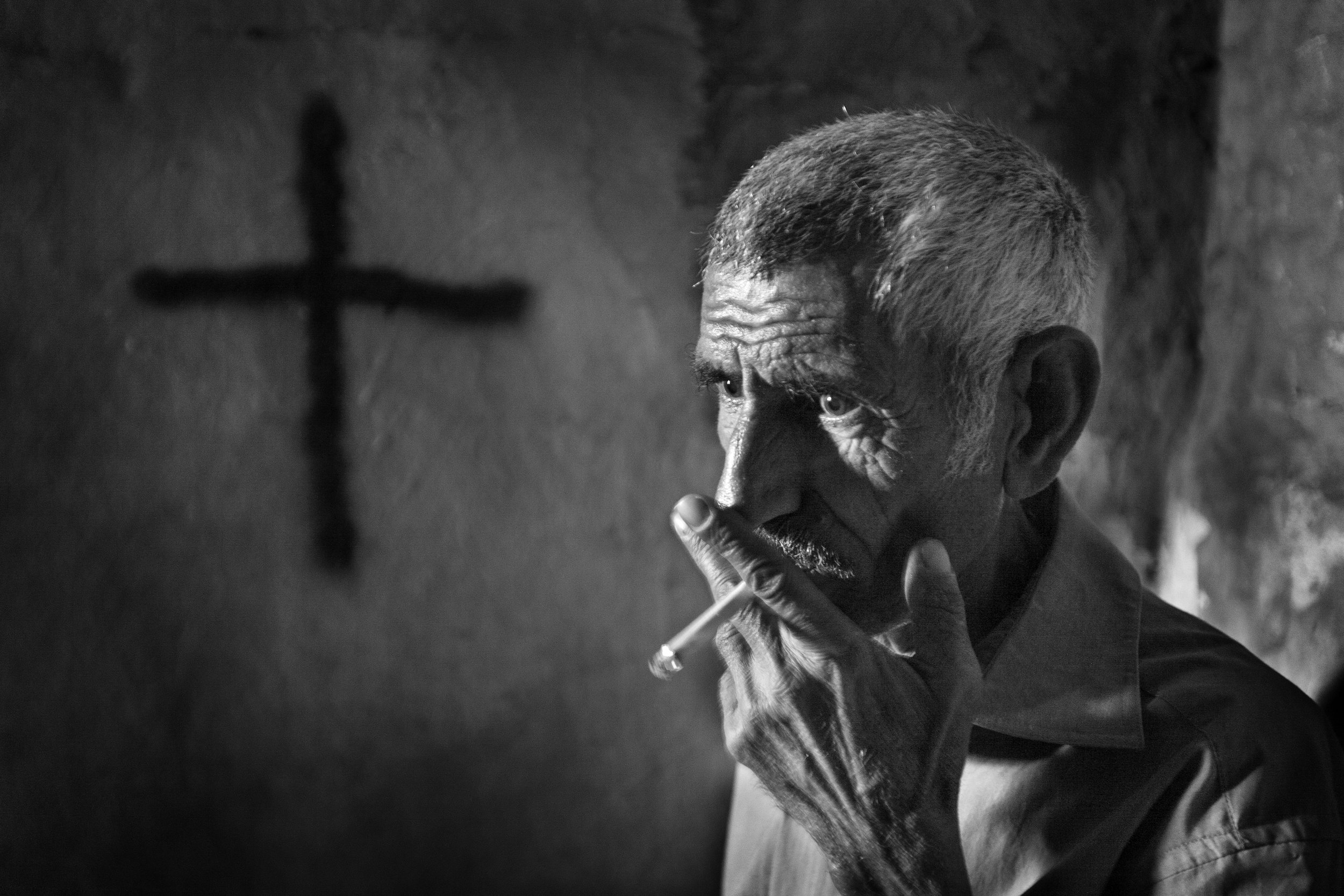  Faraj Ibrahim Hermez steps out for a cigarette in Beirut, Lebanon on April 12, 2008. Hermez's family was driven away from their home in Iraq by continuous death threats. Like 40% of Iraq’s Christian population, the family has resettled in Bouchrieh.