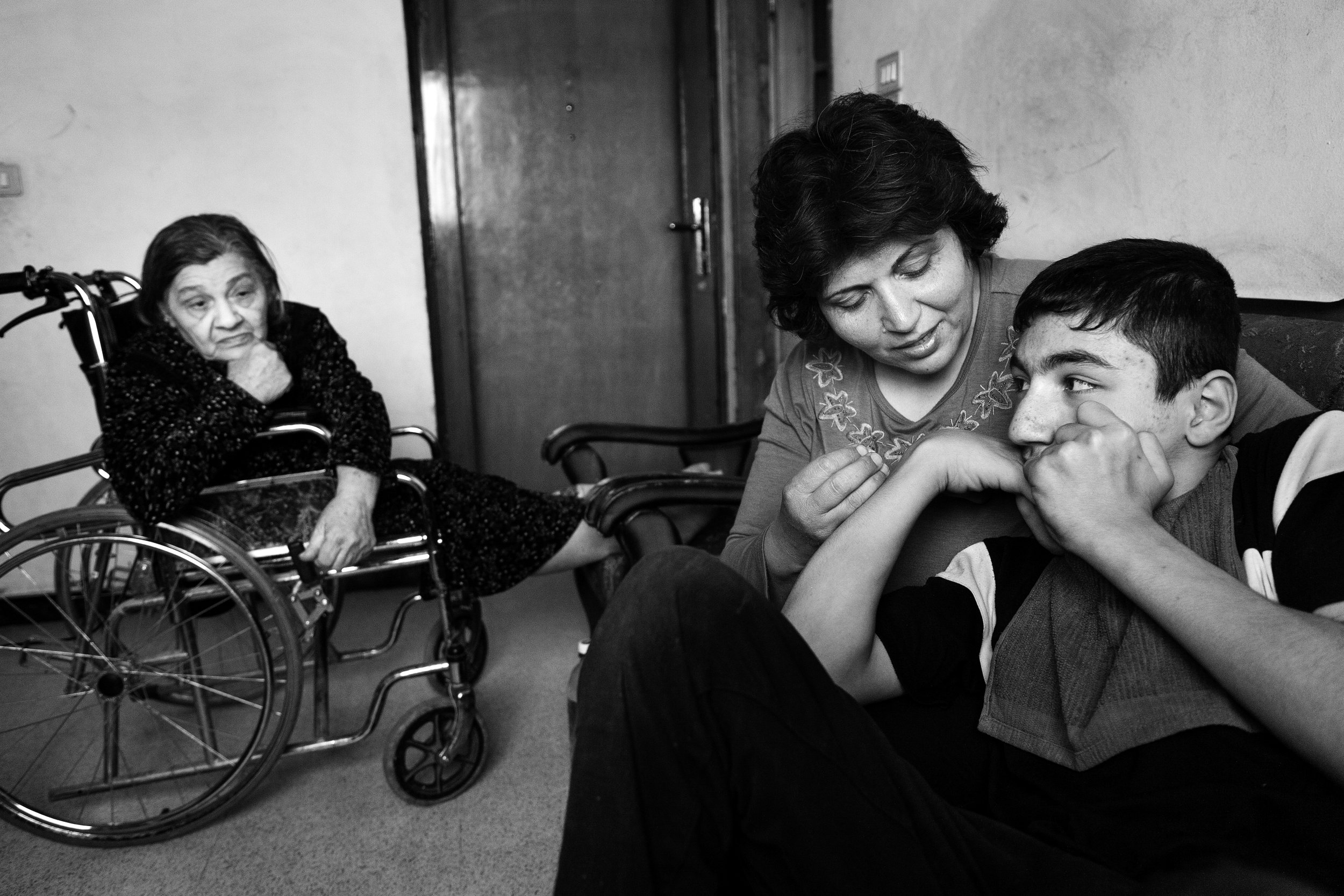  Sabah Said Rafo, her disabled son, Nour, and her wheelchair-bound mother converse in their newly-established home in Damascus, Syria in 2008. The family fled a turbulent life of violence, sectarian threats, and kidnapping in Iraq. 