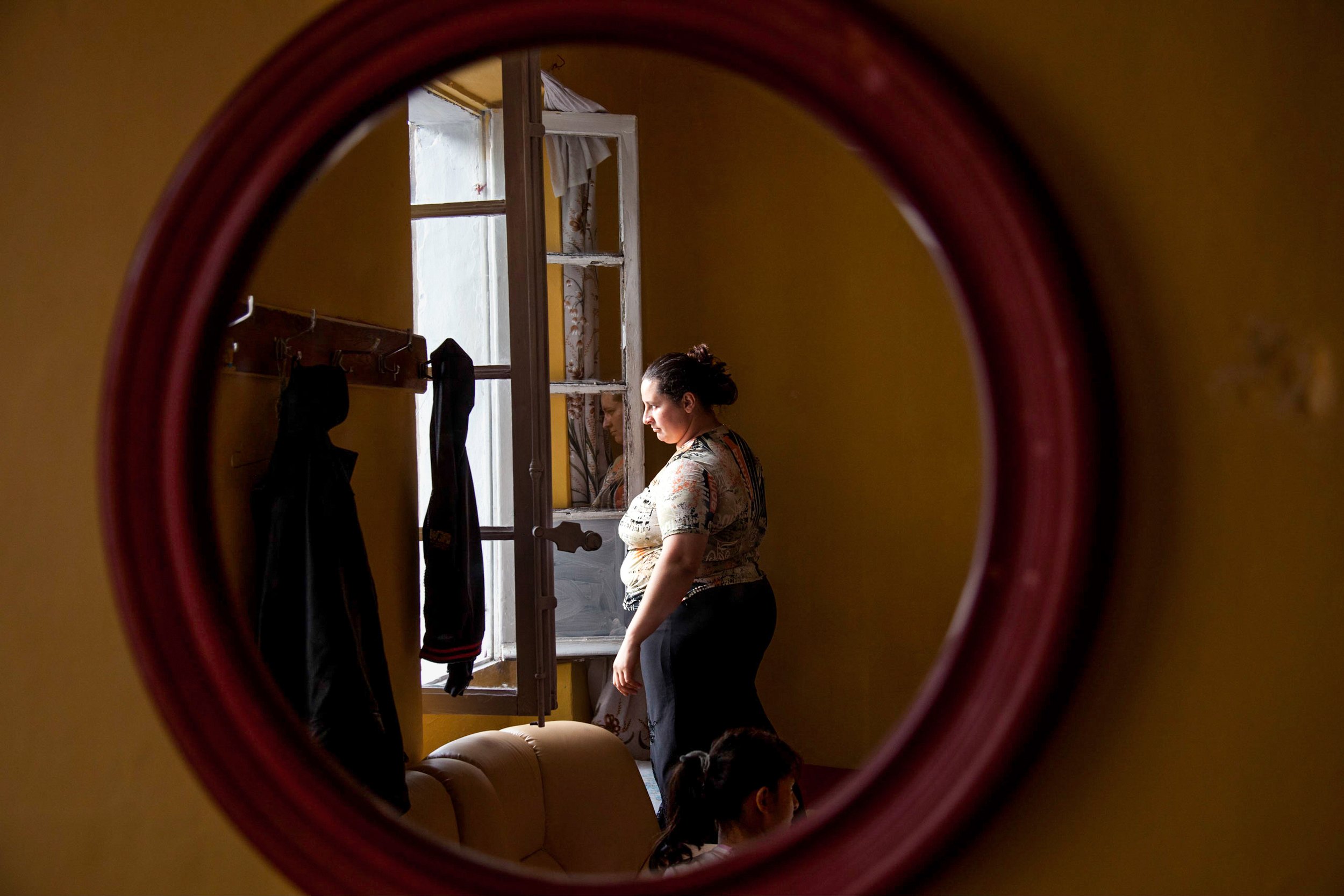  Estera Lungu looks out her window in an illegal squat in Marseille, France on Sept. 21, 2010. 