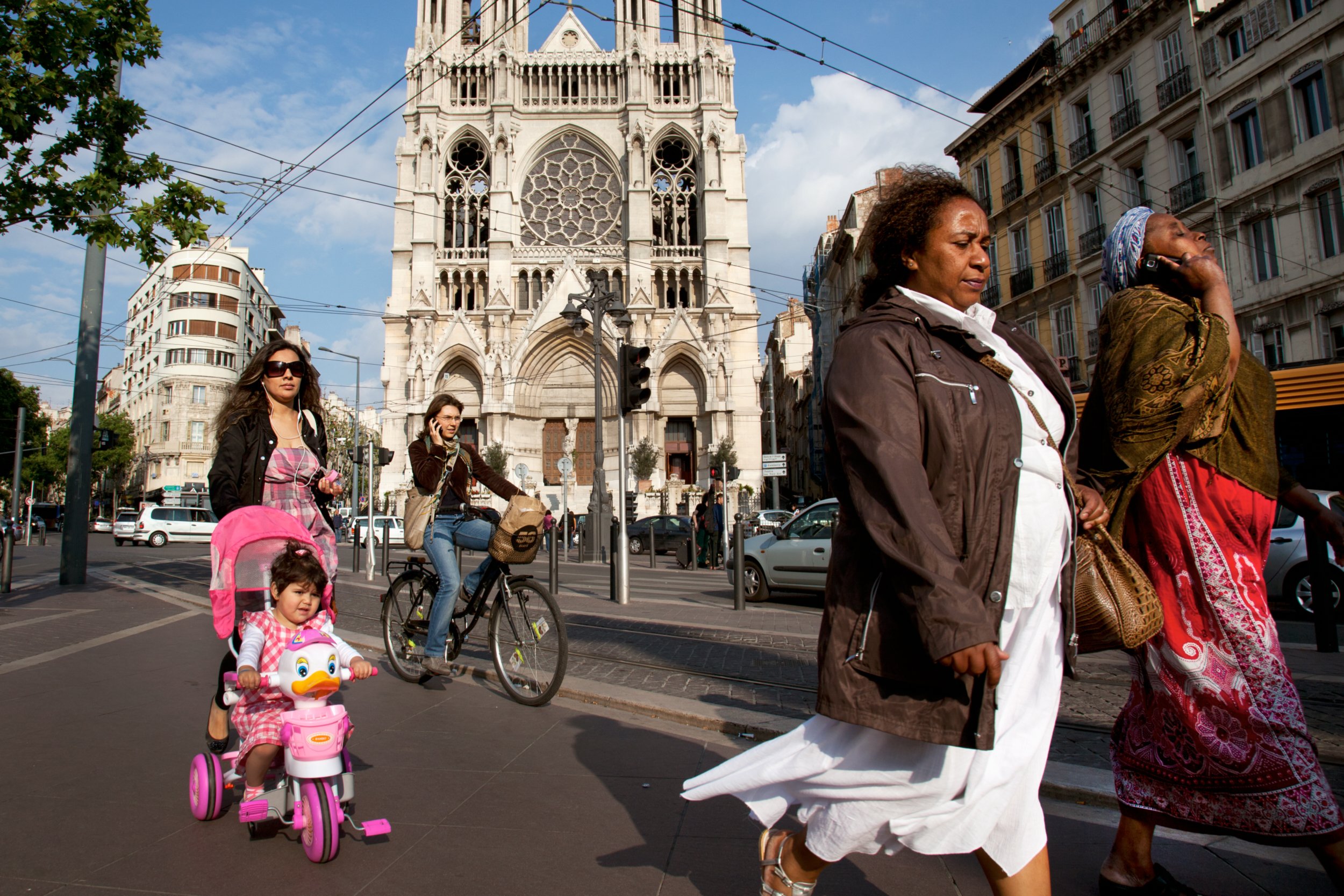  A rich tapestry of people pass the Le Reforme Church in Marseille, France on April 30, 2011. 