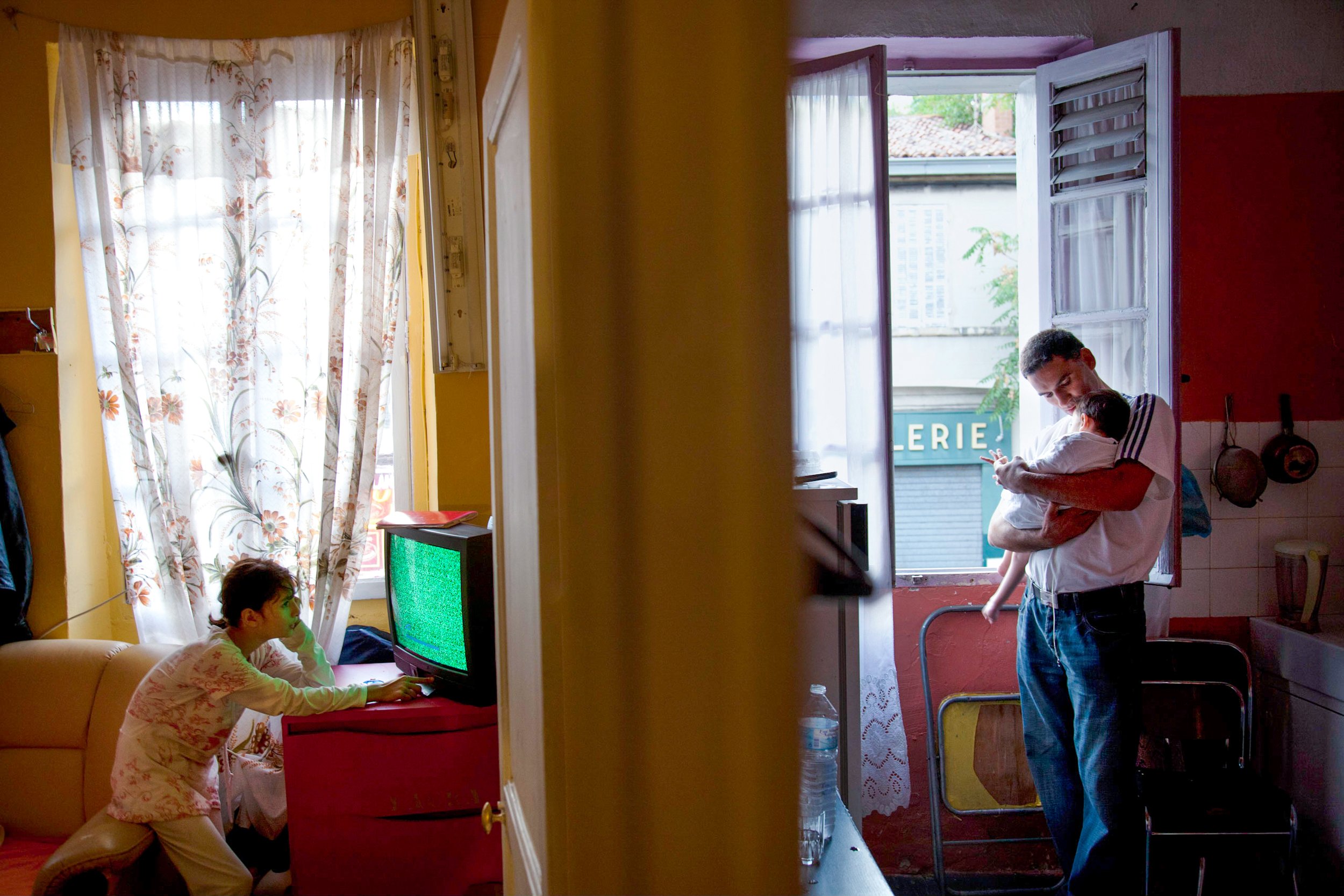  Cornell Lungu, 36, holds his son Lionel David, in their home in Marseille, France on Sept. 21, 2010. Lungu's family is a Roma family from Romania who has migrated for economic and health benefits. They illegally squat in this apartment. 