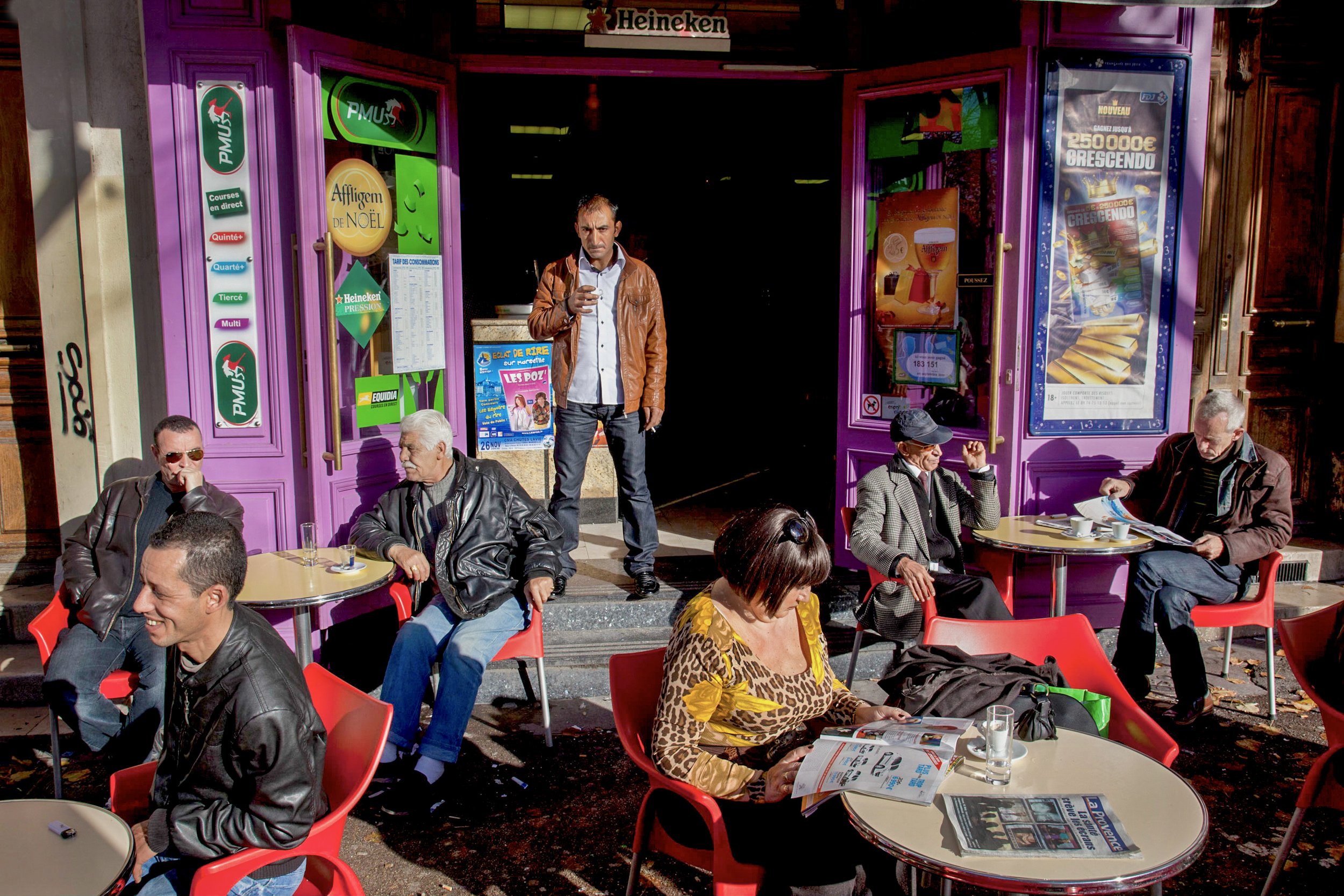  A mixed crowd of people socialize at a small cafe in Marseille, France on Nov. 21, 2010. 