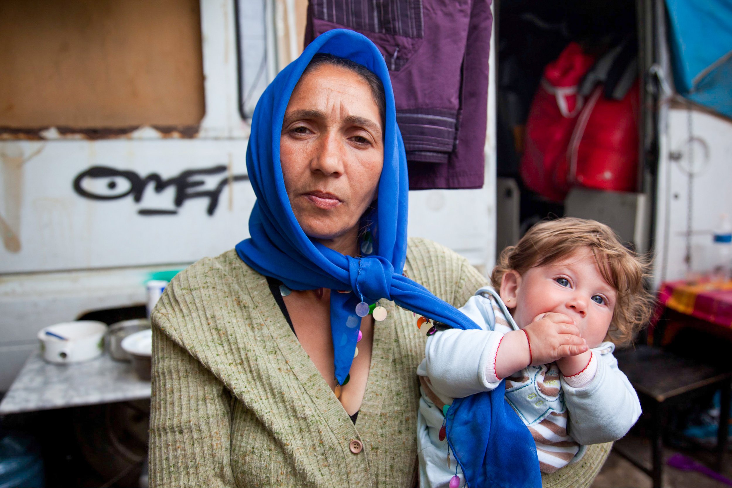  A woman holds her child outside her home in a Roma encampment in the 10th District of Marseille, France on May, 2, 2011. 