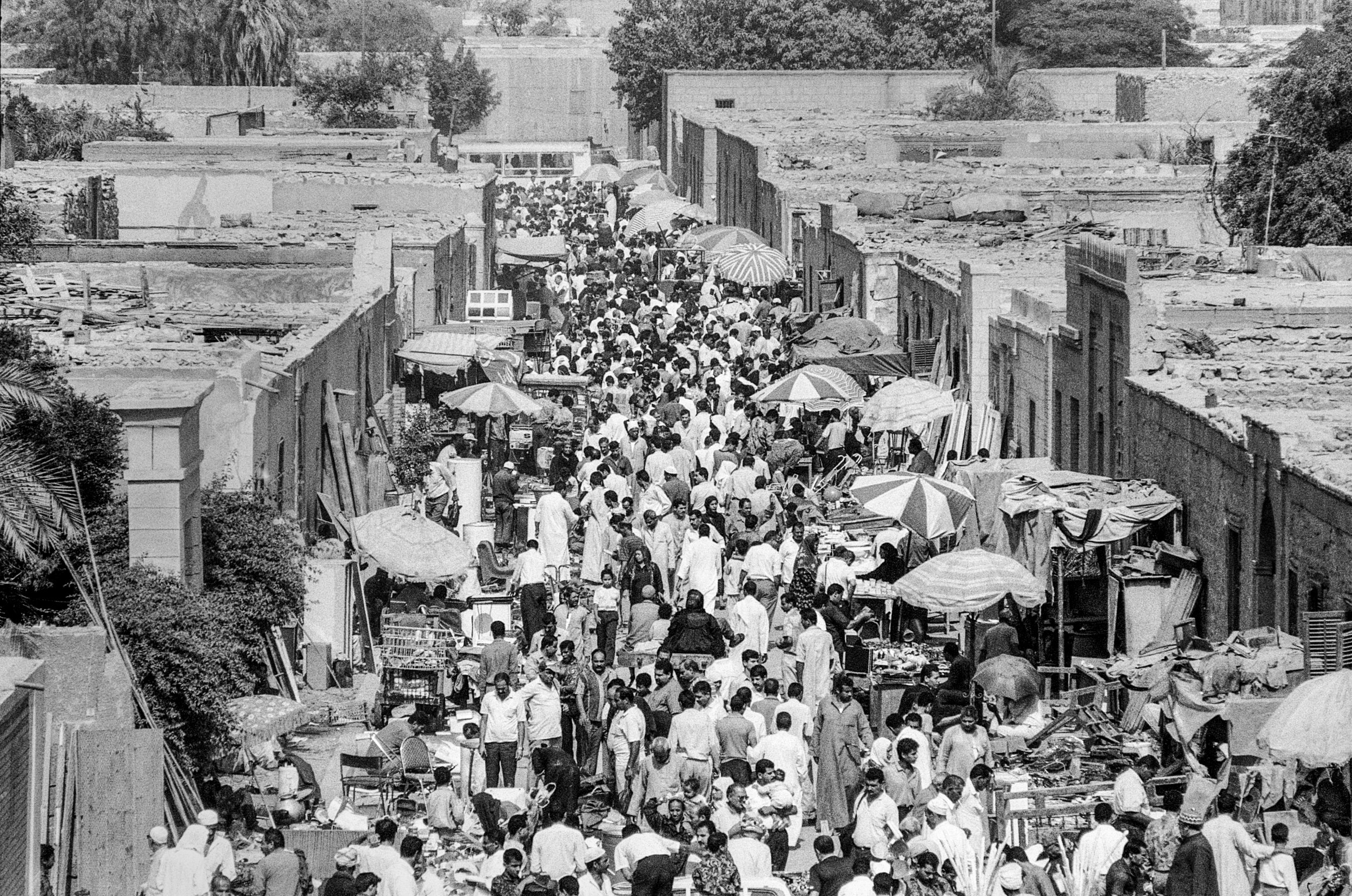  Crowds of people visit the local market. 