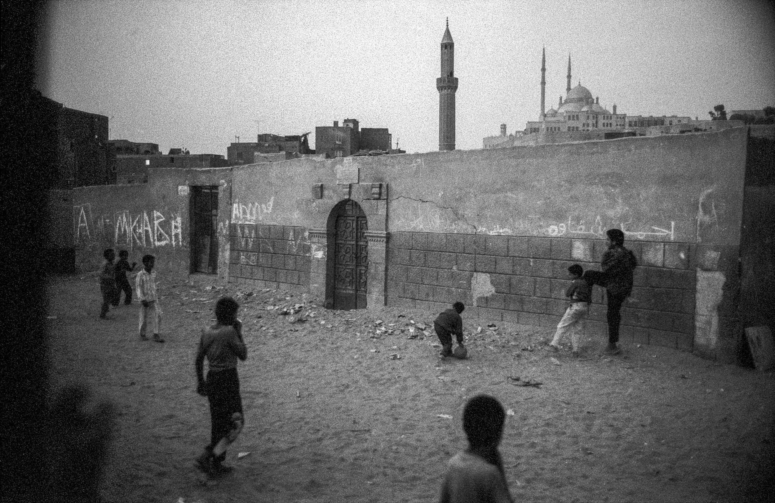  Local kids play soccer in between the tombs and mausoleums.  