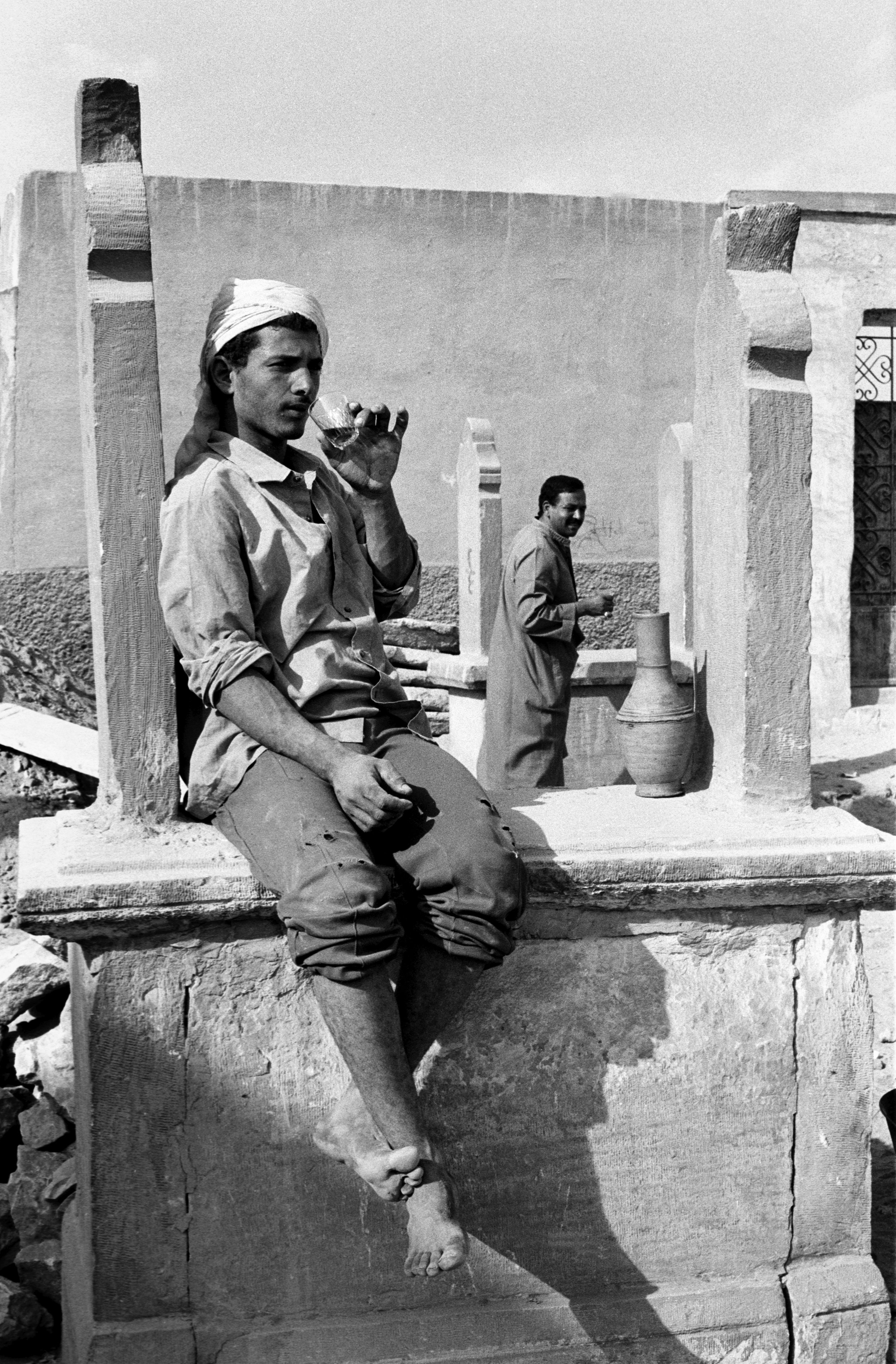  A grave digger takes a tea break. The monuments are stone structures that sit above ground, and the bodies are buried in the chambers below. 