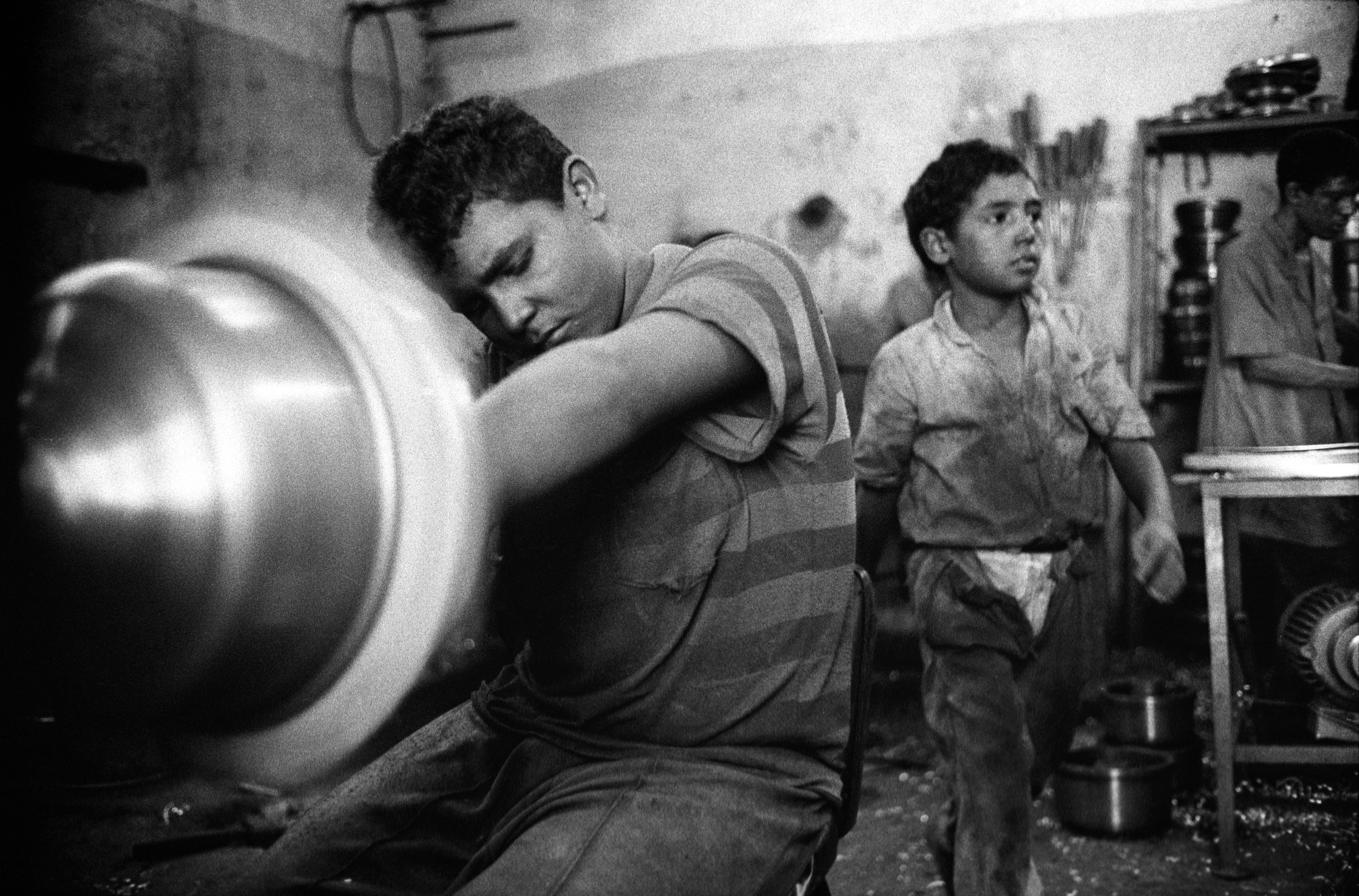  More than 200 boys work daily 8 hour shifts in an airless, makeshift aluminum pot factory. 