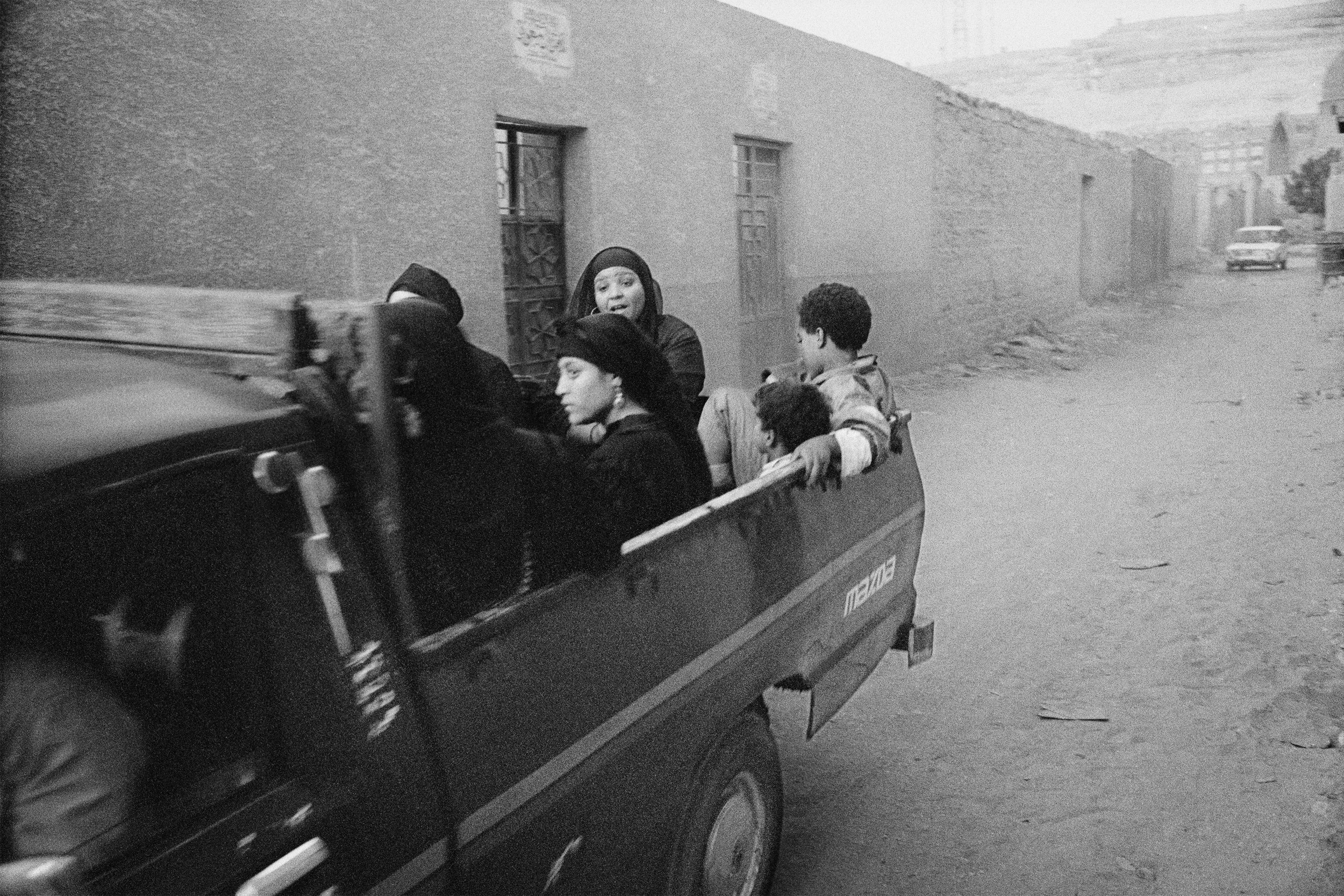  A truck speeds down an alleyway between mausoleums in the City of the Dead. 