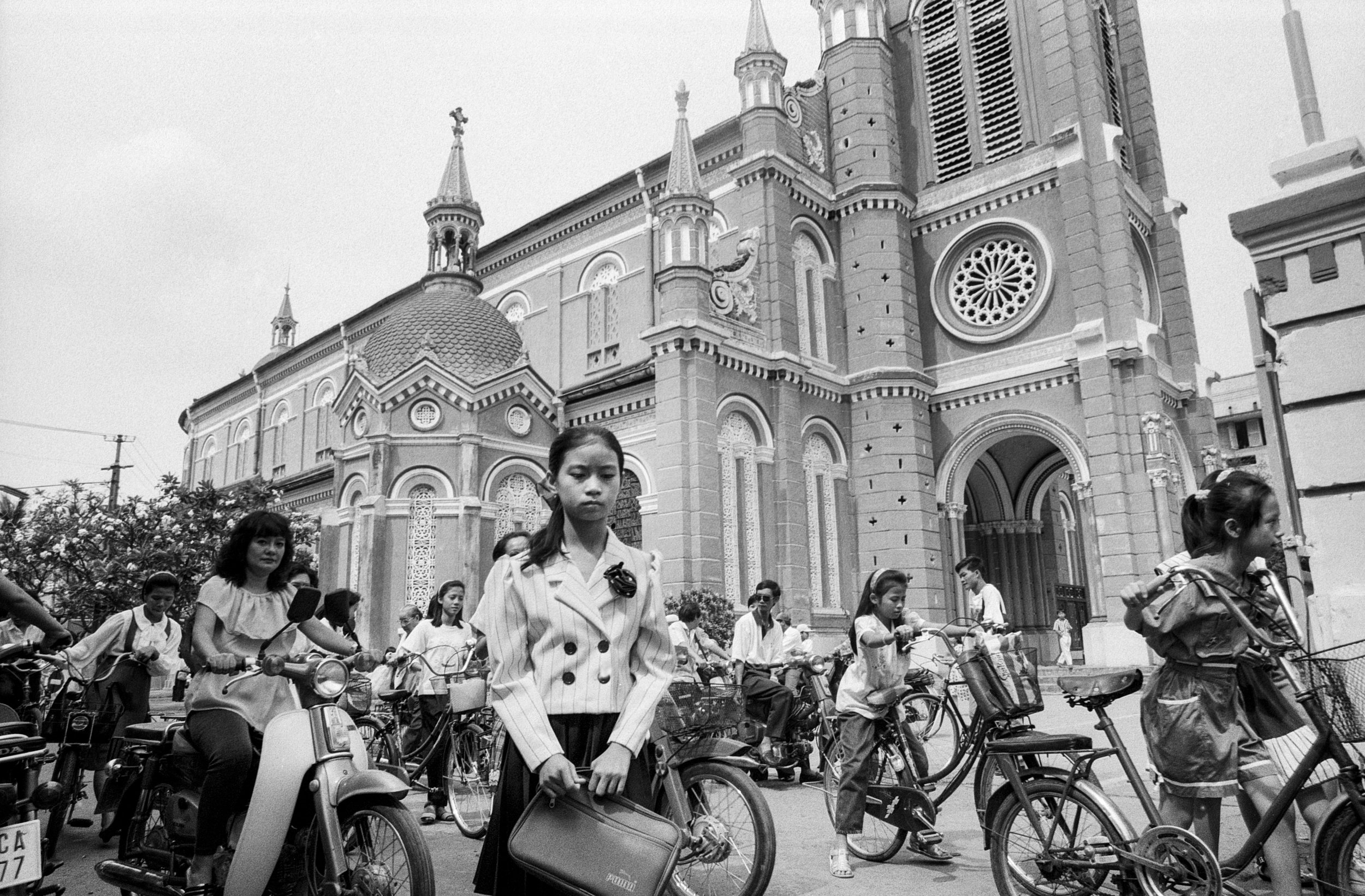  A young schoolgirl stands outside of the Duc Ba, or Notre Dame Cathedral. 