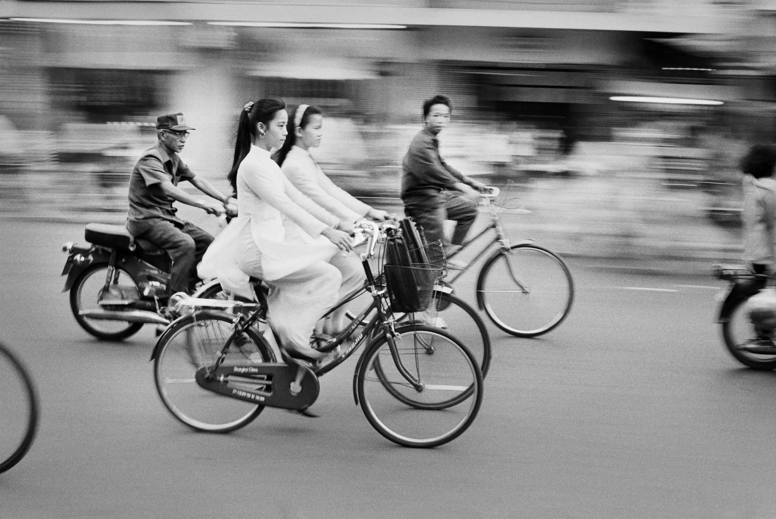  The morning commute finds young schoolgirls dressed in the traditional Ao Dai. Pre-communist fashions have made a big comeback since the late 1980s when the government began to loosen restrictions. 