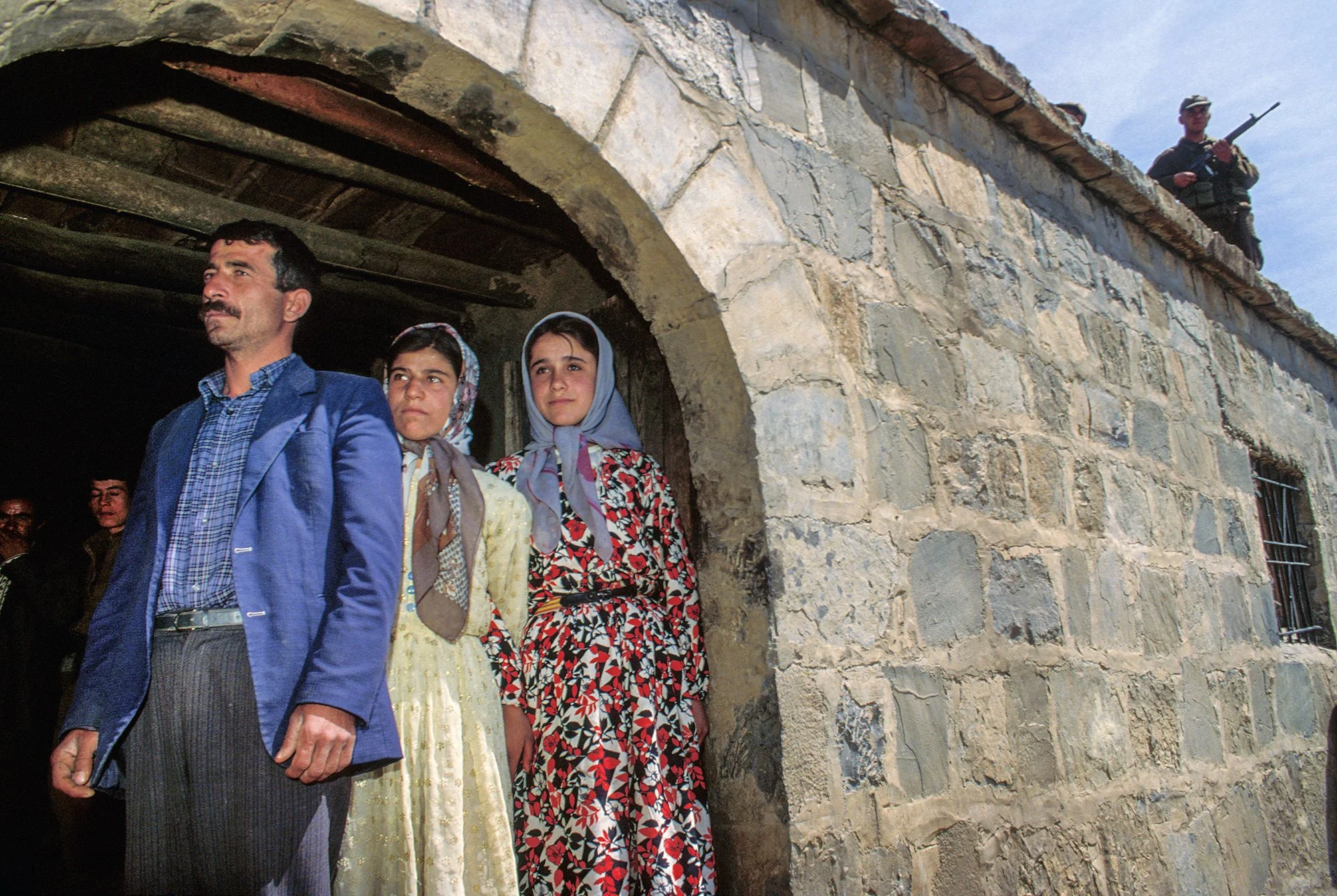 Living under the pressure of the gun in a remote village of Turkish Kurdistan, a family waits for Turkish commandos to finish a sweep for PKK guerillas. Turkey, 1991.