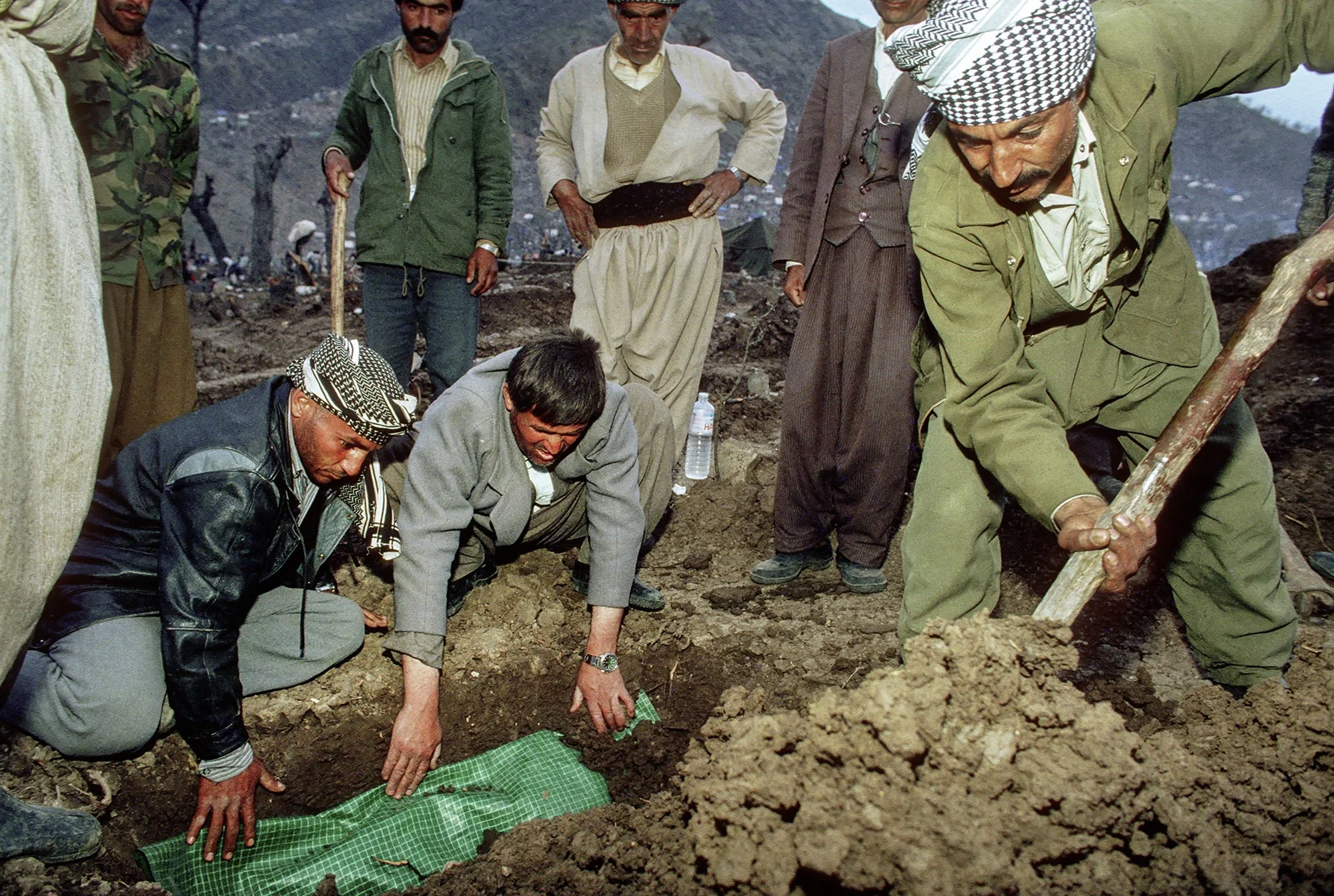 A Kurdish family buries their baby, who had just died from malnutrition, at the Ishikveren refugee camp in Turkey, 1991.
