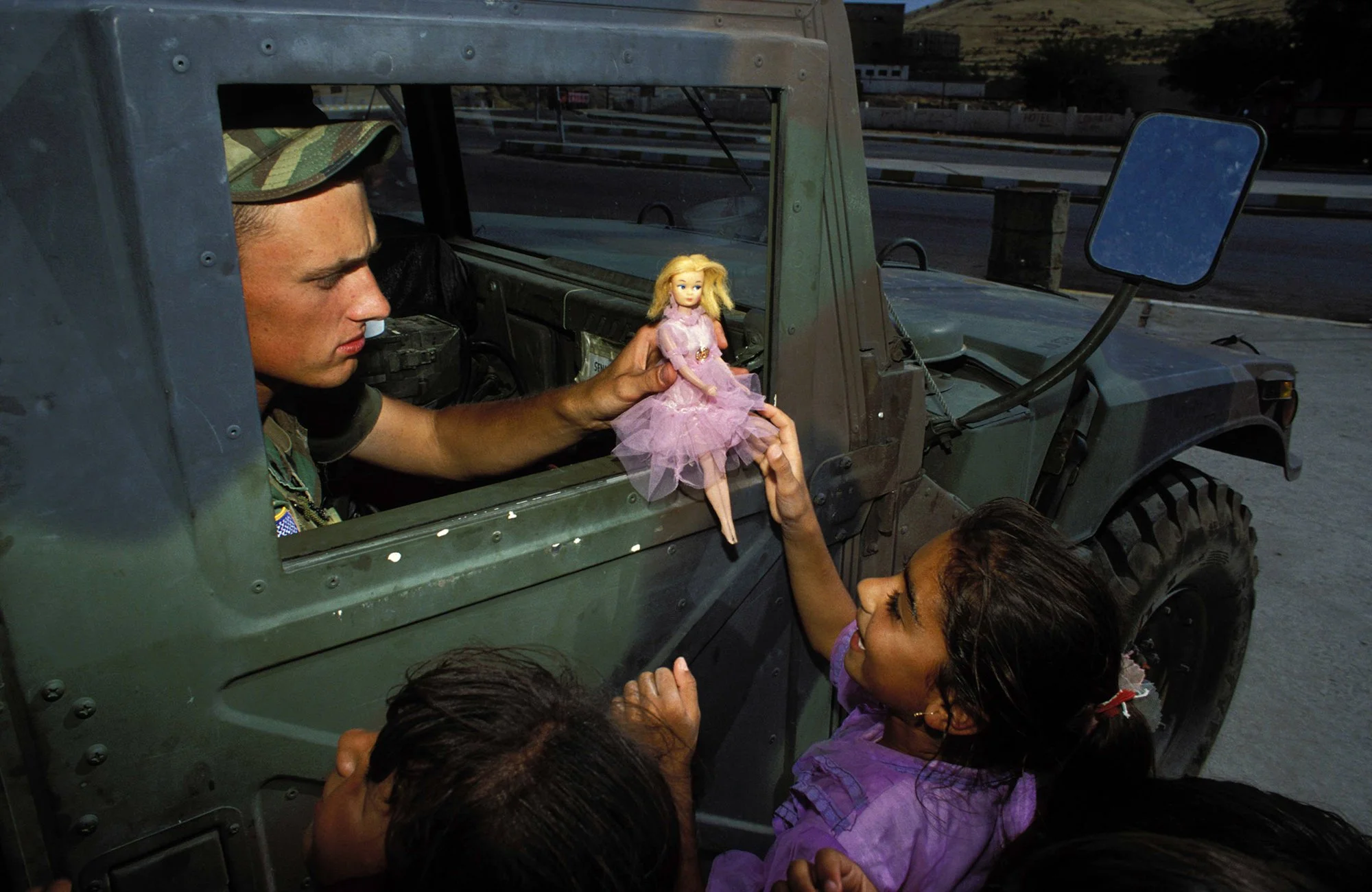 A Kurdish girl and an American GI are mutually pleased to see each other in northern Iraq, 1991. Without the Allied presence, Kurdish autonomy and perhaps this youngest girl's life would be crushed by Saddam Hussein's vengeance.
