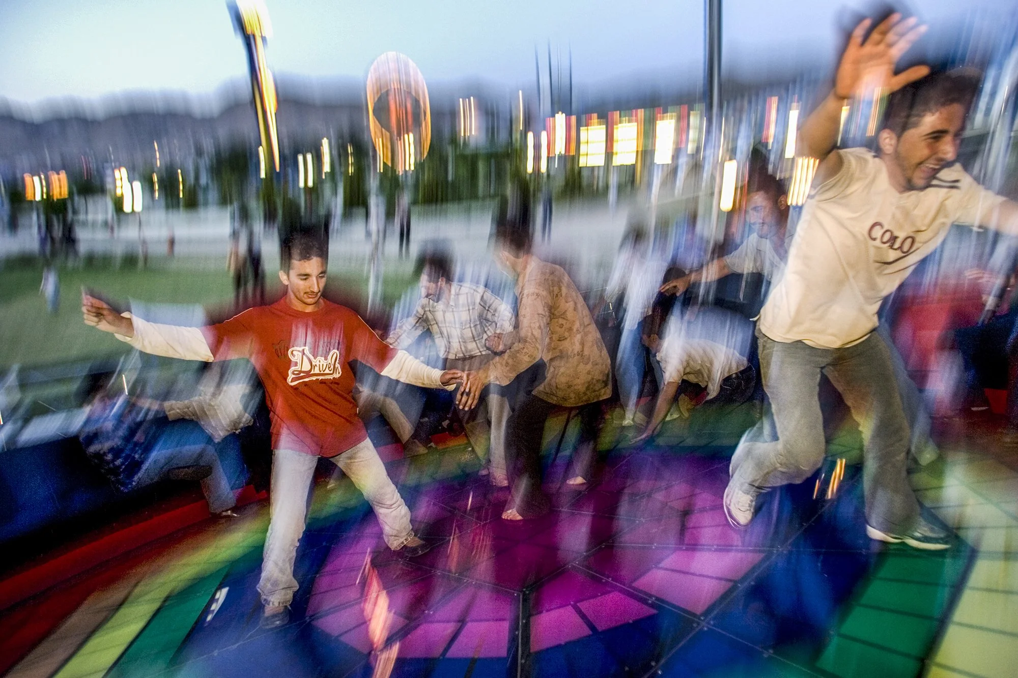 Young men have fun on a ride at Dream City, an amusement park in Dohuk City, Iraq on April 29, 2005.