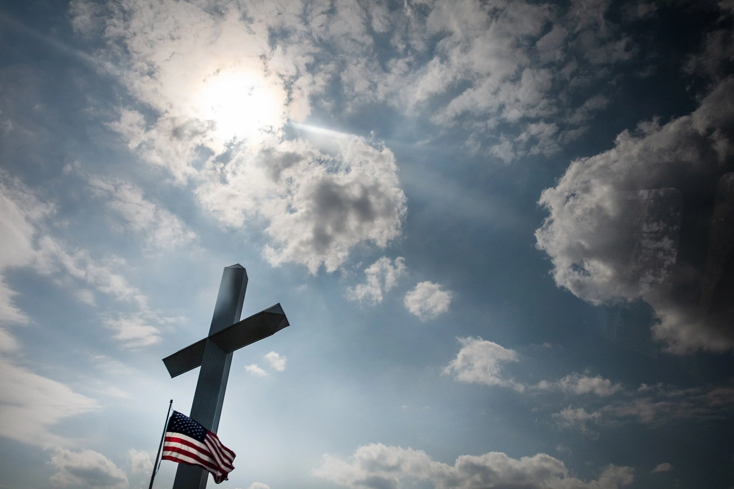  Passing a large cross and American flag near Greenwood, Mississippi on September 4, 2025. 