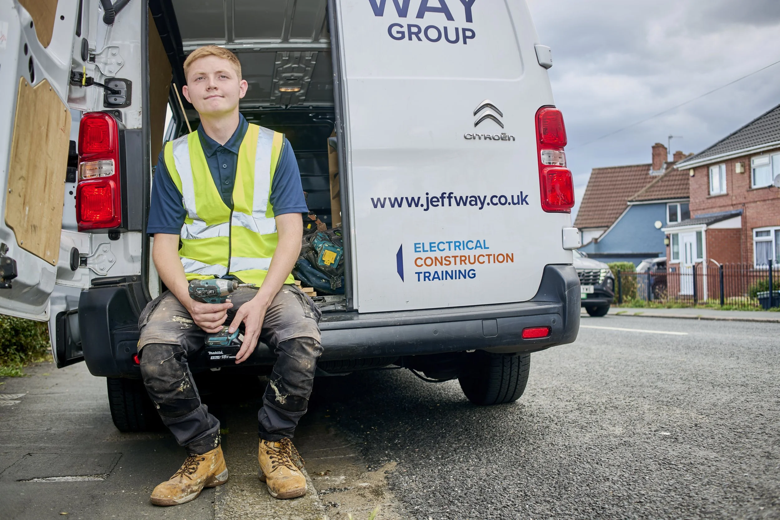 Jeff Way Group apprentice sitting in the back of an electrical construction training van