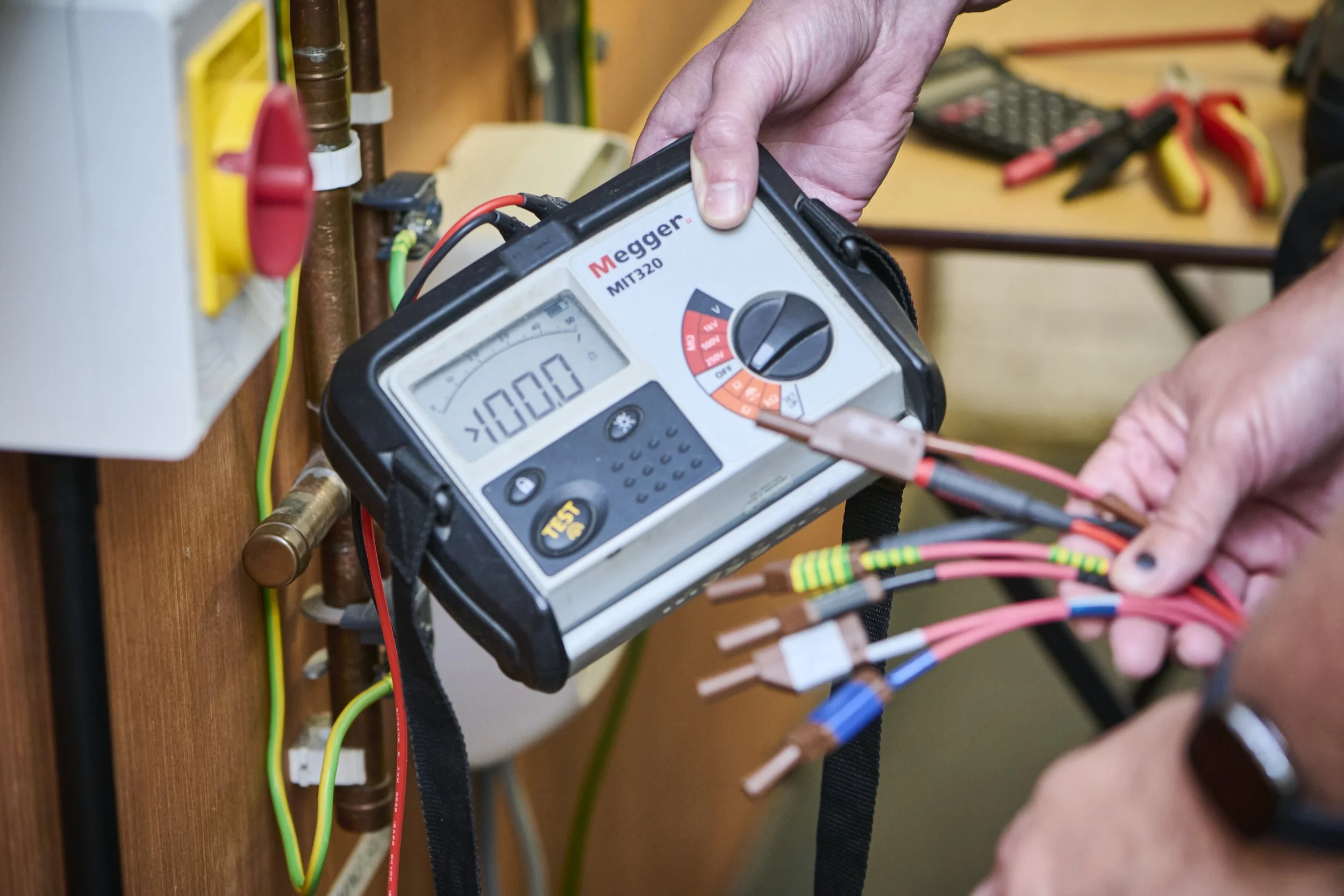 Electrician testing a circuit with a Megger insulation tester
