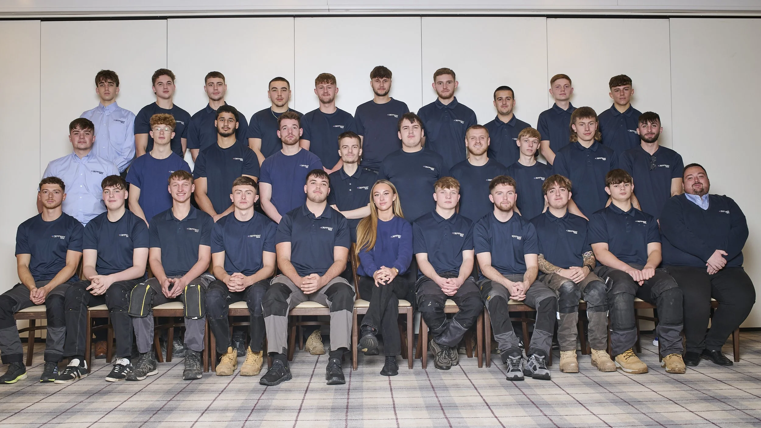 Group photo of Jeff Way Group apprentices and staff in company uniform