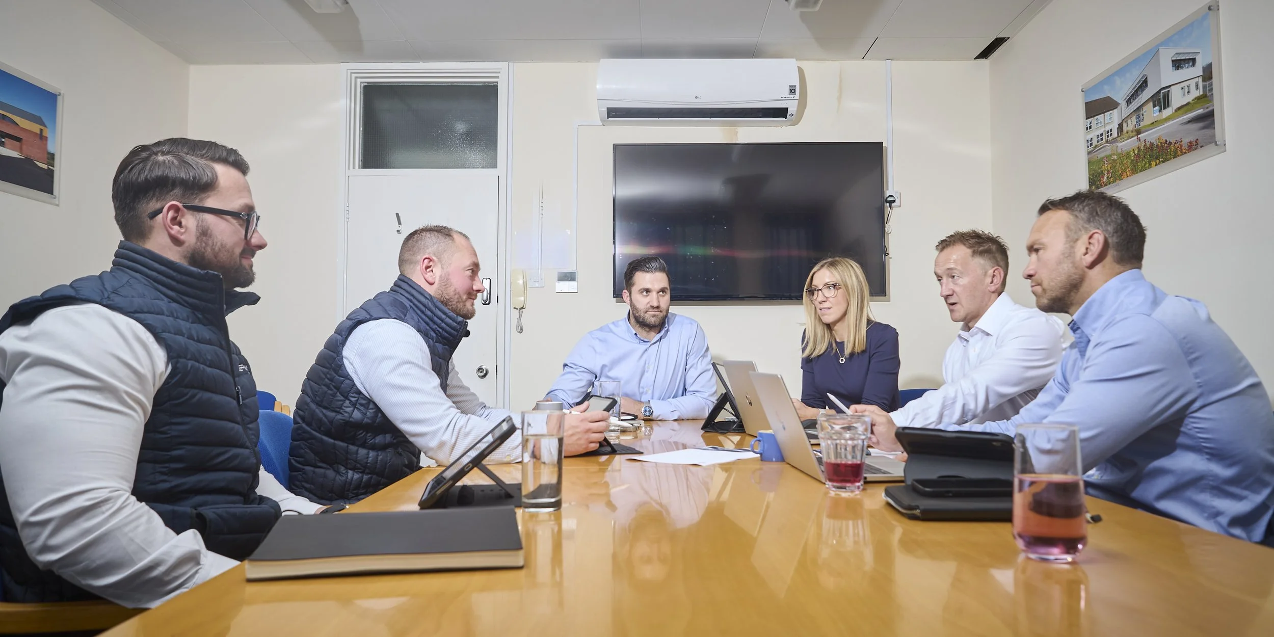 Jeff Way Group managers in a meeting around a boardroom table