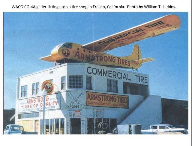  A 1950s photo taken by William T. Larkins shows a retired WWII-era WACO CG4A glider used as a rooftop advertisement for a tire shop in Fresno, California. 
