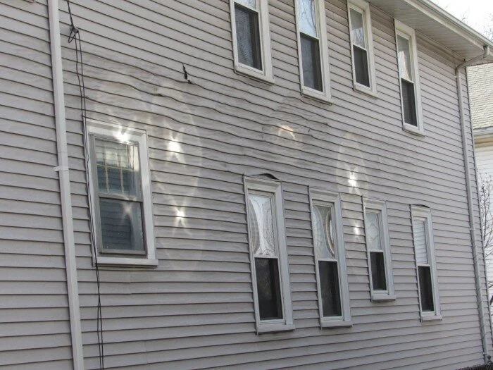 Melted vinyl siding caused by reflected sunlight