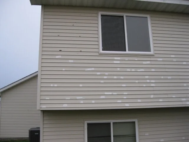 Damaged vinyl siding.JPG