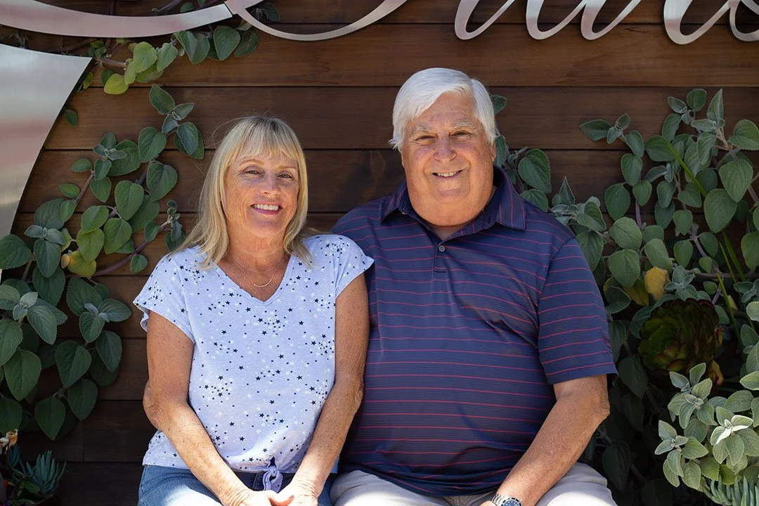 grambergu-dad-and-step-mom-on-7-stars-bench.jpg