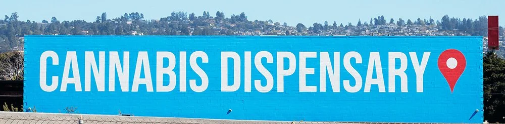 Mural with the words "cannabis dispensary" in white lettering with a blue background and a red location symbol.