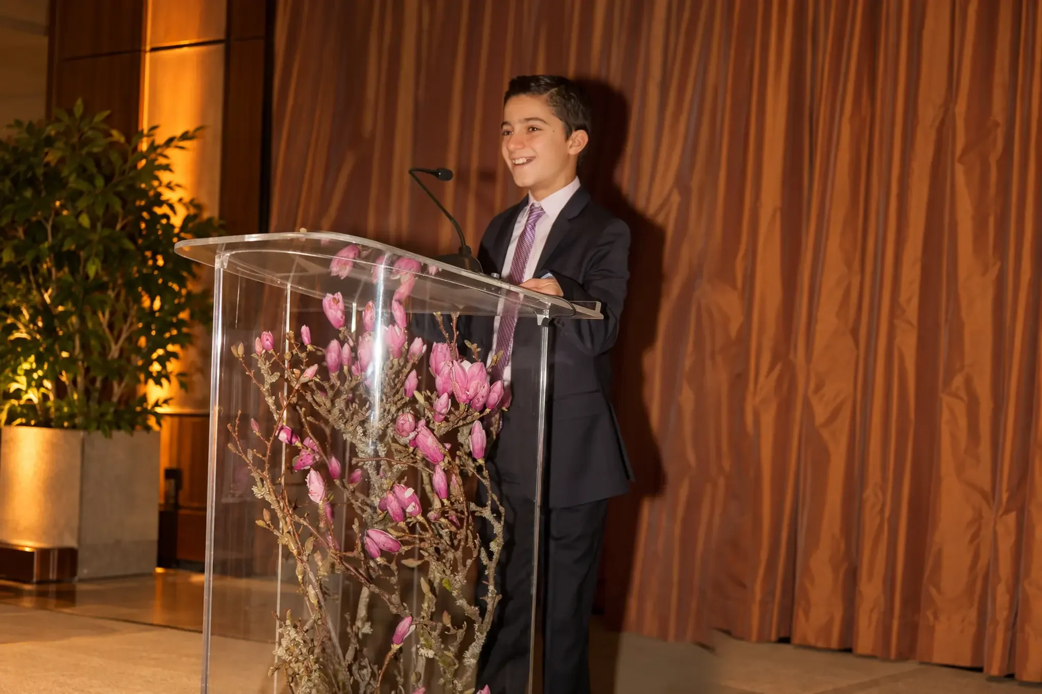 03-boy-speaking-at-lectern.webp