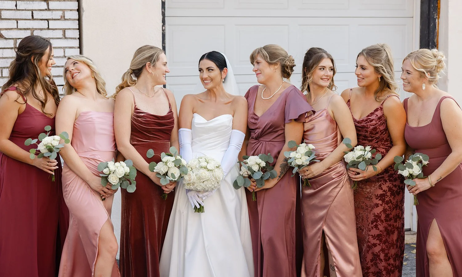 Bridesmaid and bride holding white garden bouquets designed by The Flower Lab in St. Louis.