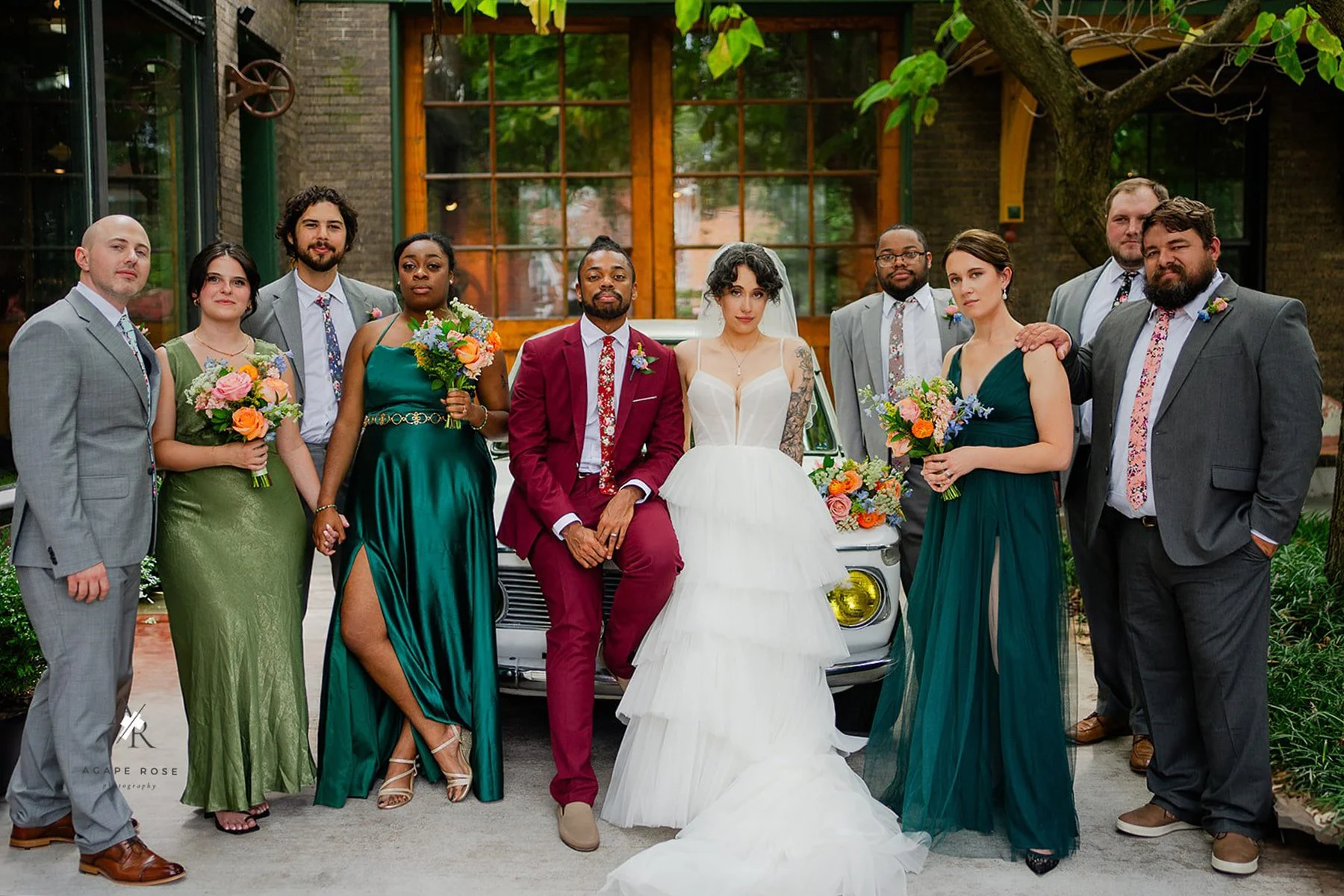 Wedding party in mix-matched attire with colorful bouquets in St. Louis.