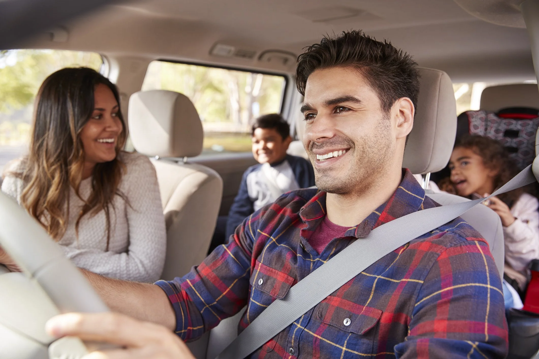 Happy family driving in their car