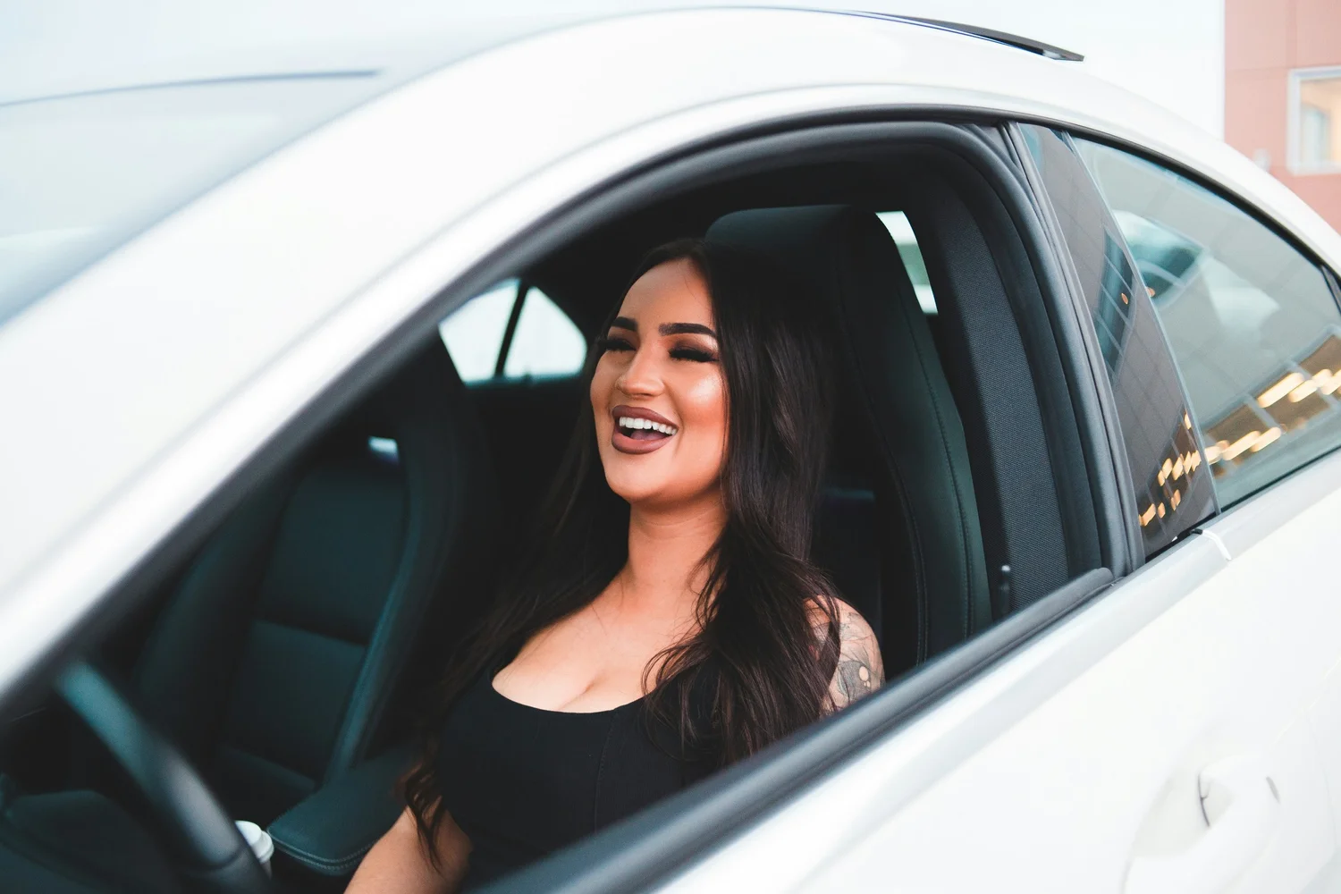 Smiling driver behind the wheel of her car in California