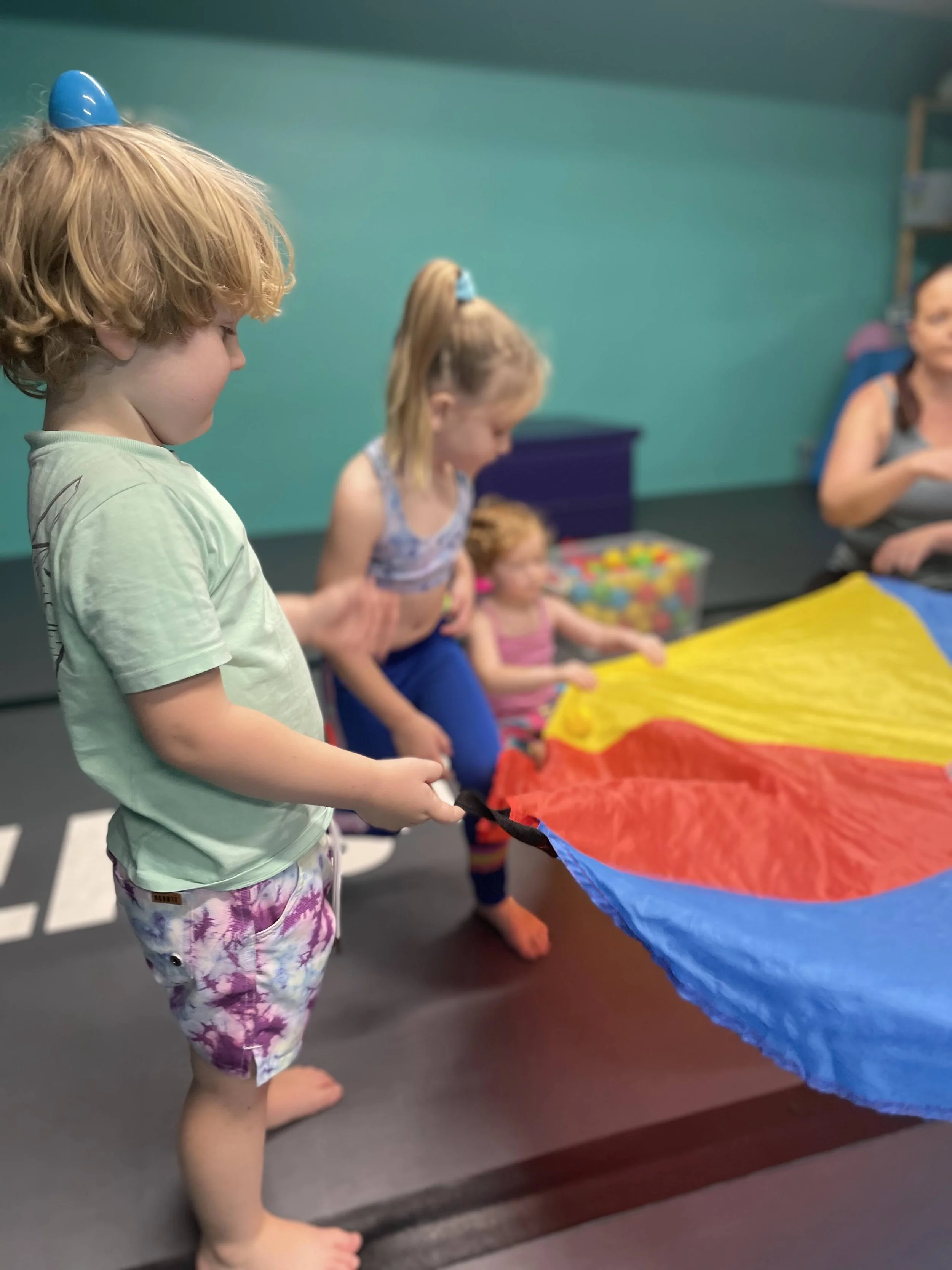 Toddler Circus Class playing with balancing and parachute games