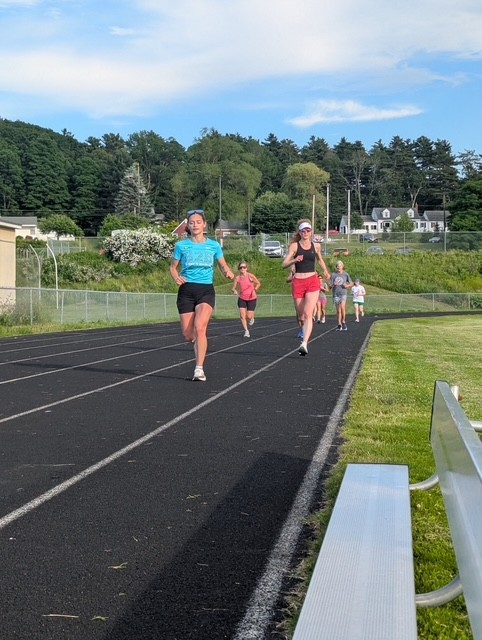 Runners performing track workouts