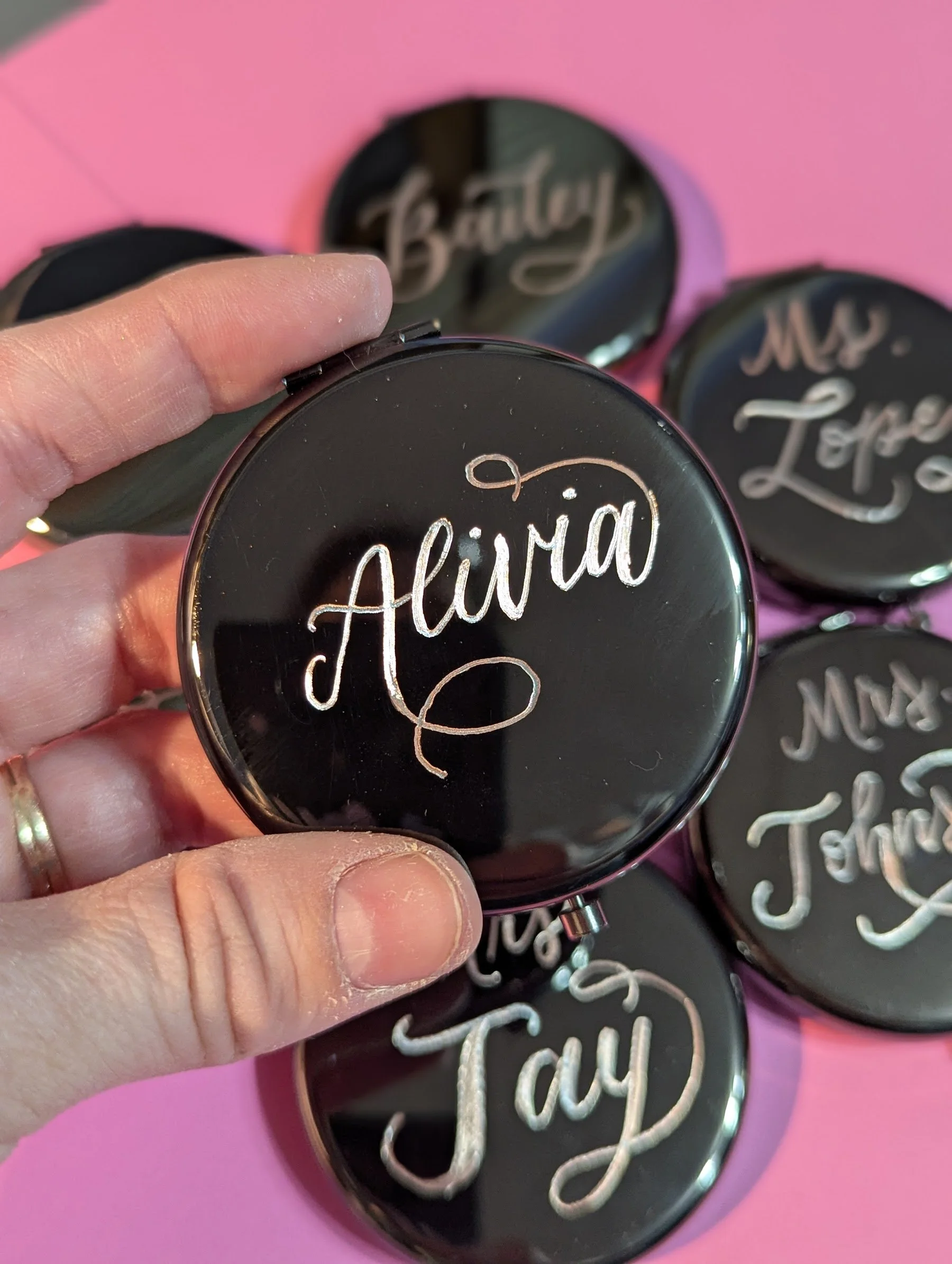 Custom hand engraved name done in calligraphy on a mirror compact