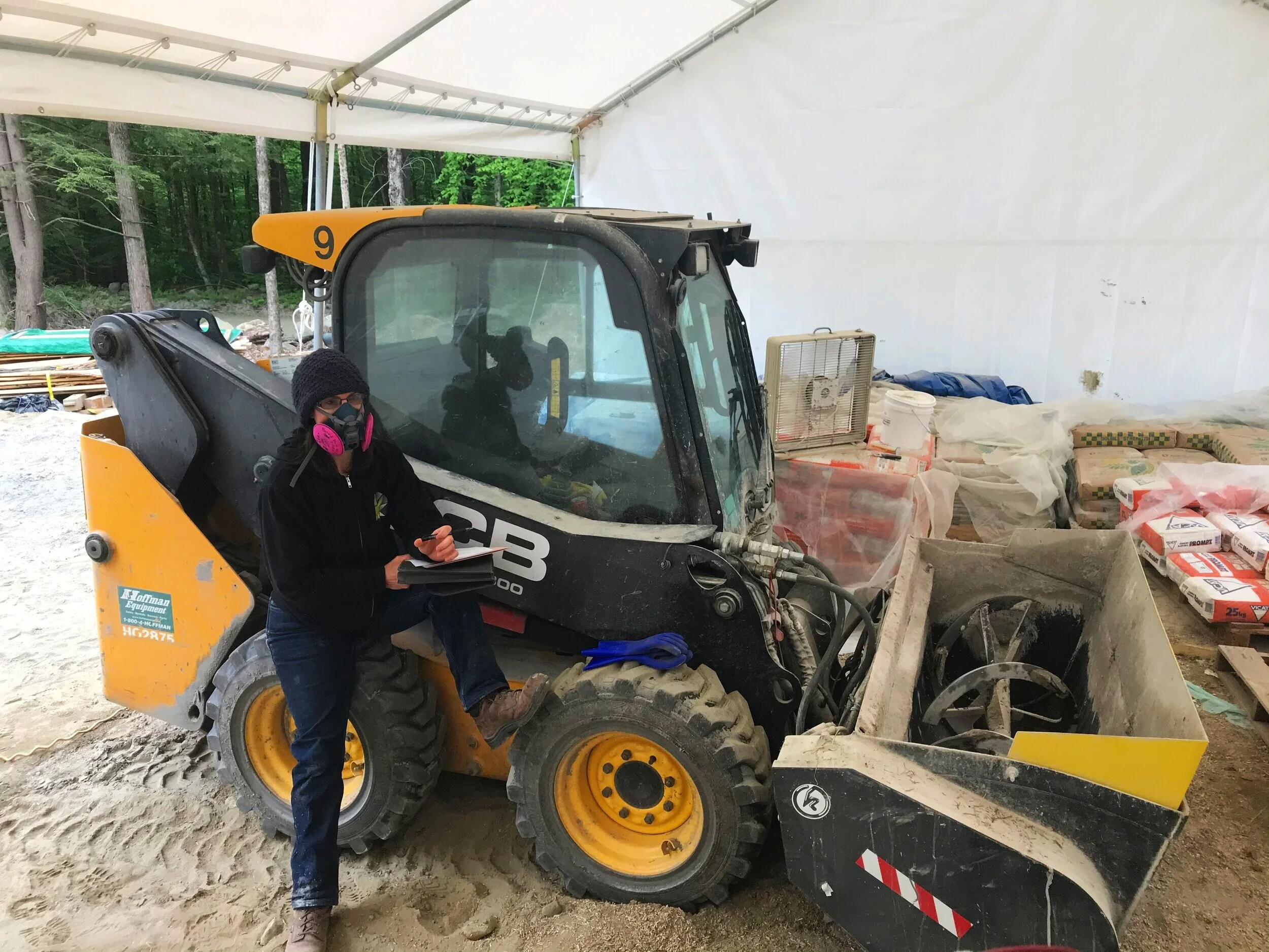 Jennifer Martin, Catalyst at HempStone, with a skidsteer fixed with a mixing bucket