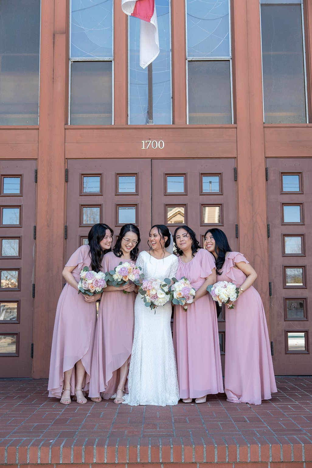 Bridesmaids smile together for the bride's Bay Area wedding photos in Alameda, CA.