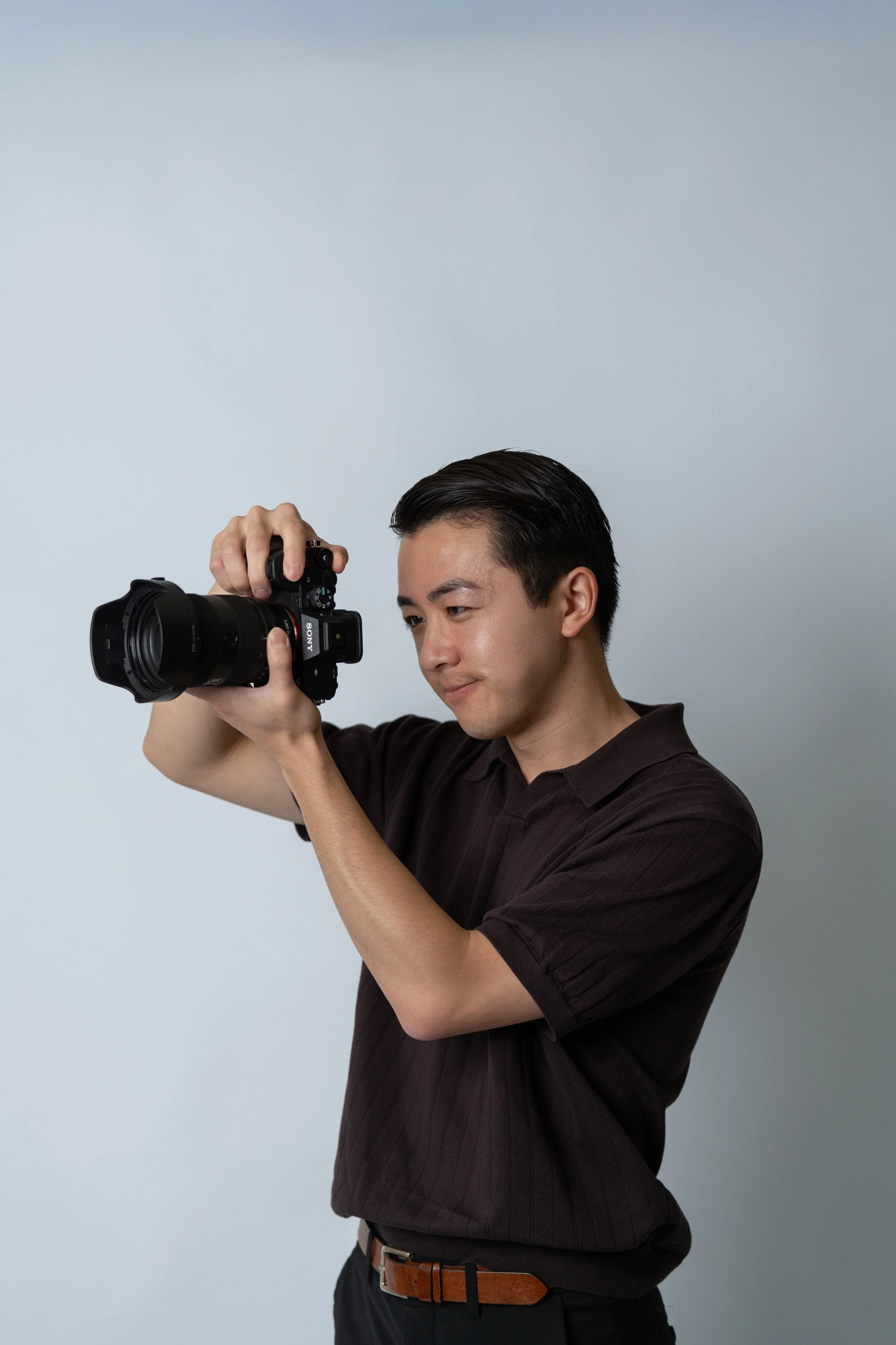 San Francisco Bay Area wedding photographer holds camera to take photos