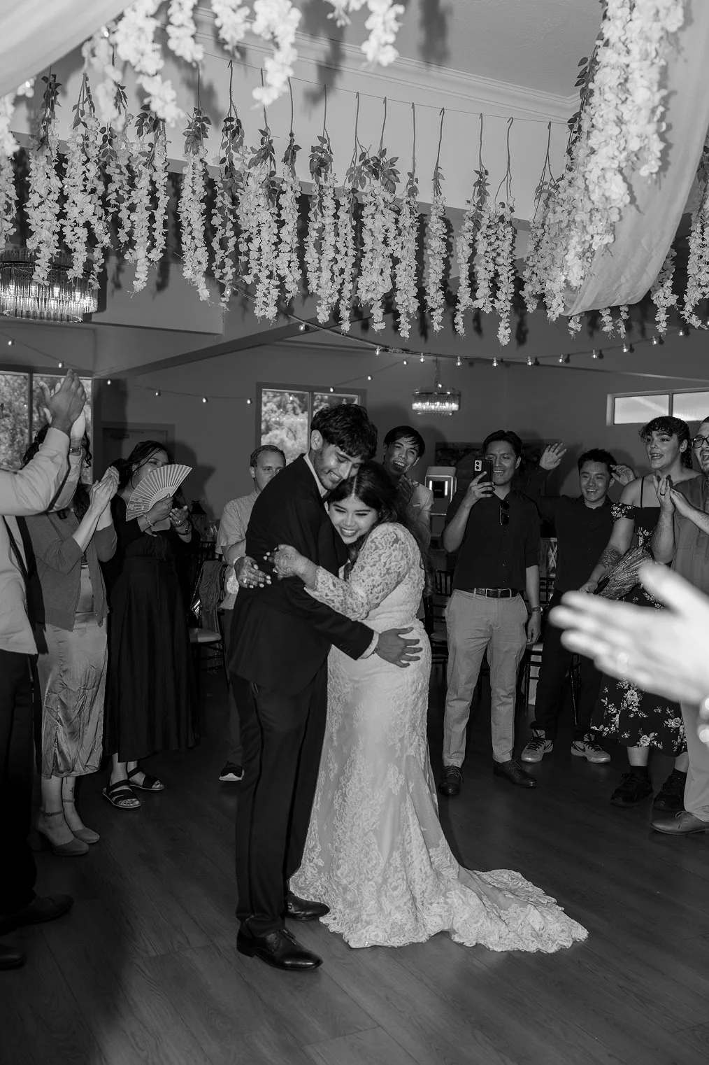A couple hugs during their reception for their Redwood Canyon wedding photos in Castro Valley.