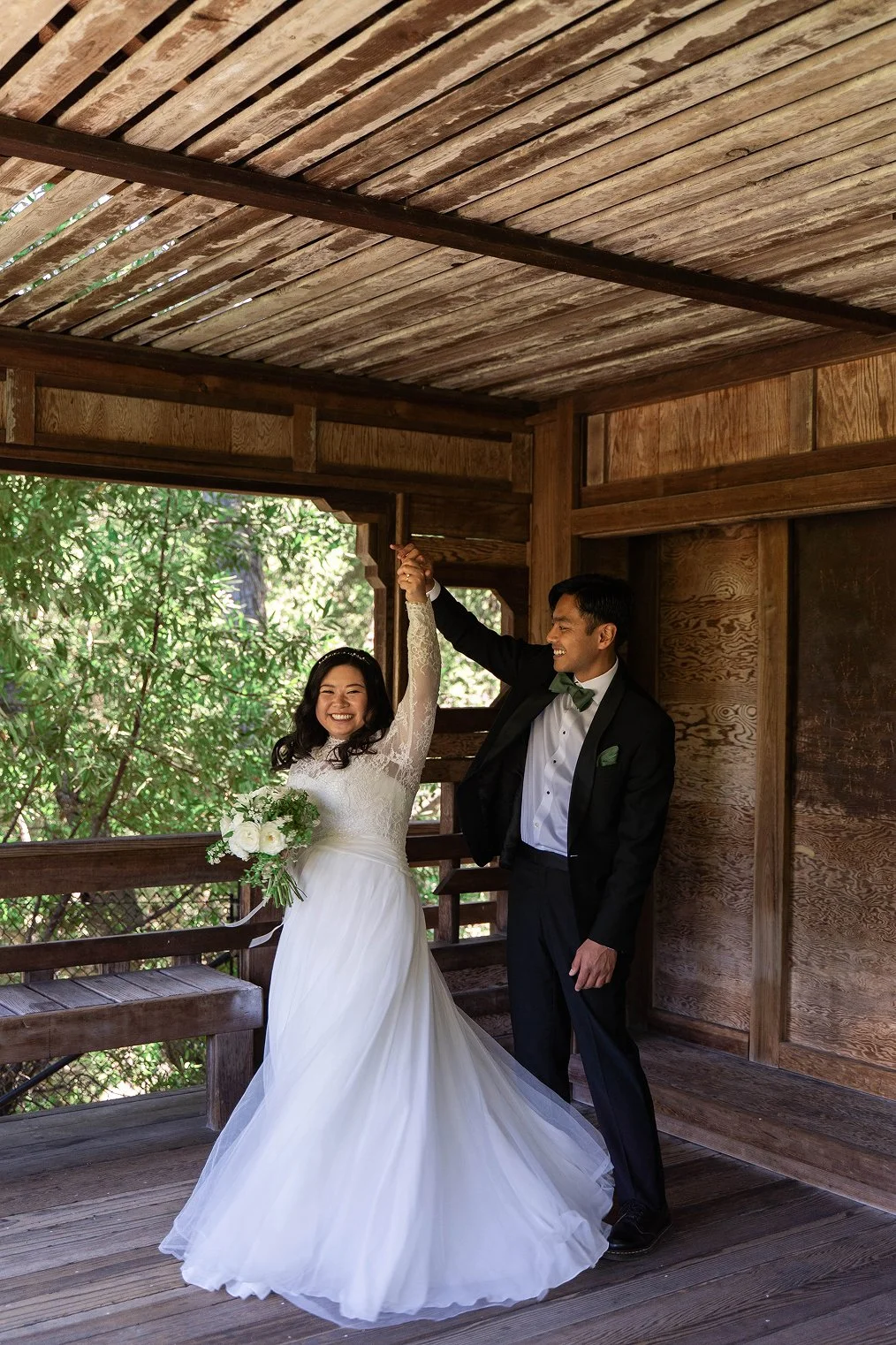 A couple smiles together at the Hayward Japanese Gardens for their Bay Area wedding photos.