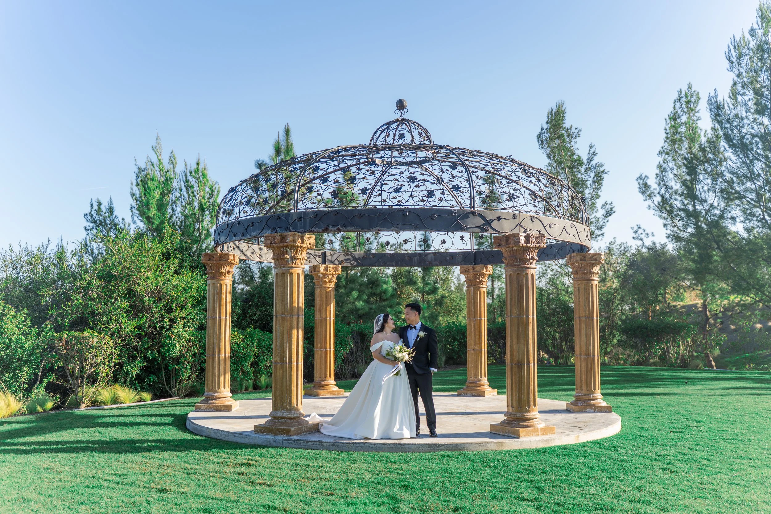 Bride and groom smiling at each other at Vellano Estate wedding in Chino Hills