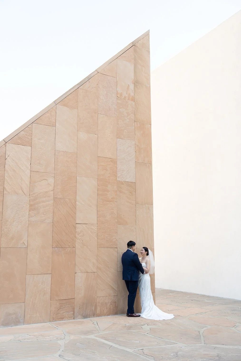 A couple holds each other while taking their Orange County wedding photos.