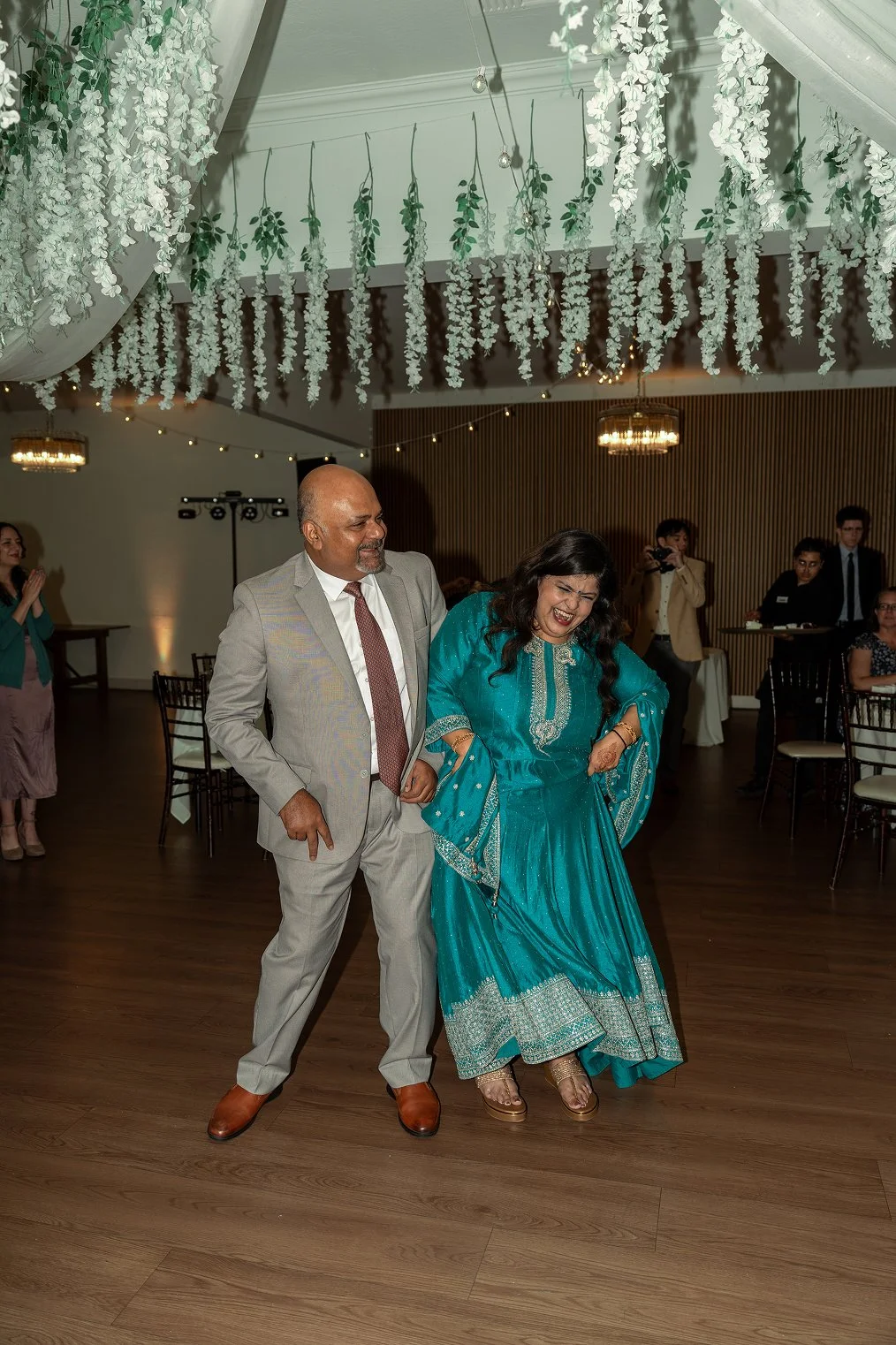 A mother and father dance together during their daughter's Redwood Canyon wedding photos.