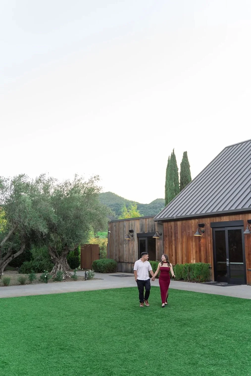 A couple walks together at The Estate Yountville while taking Napa engagement photos