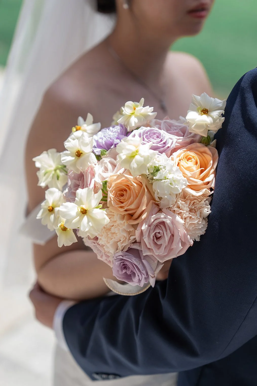 A bride holds her flower bouquet for her Bay Area wedding photos.