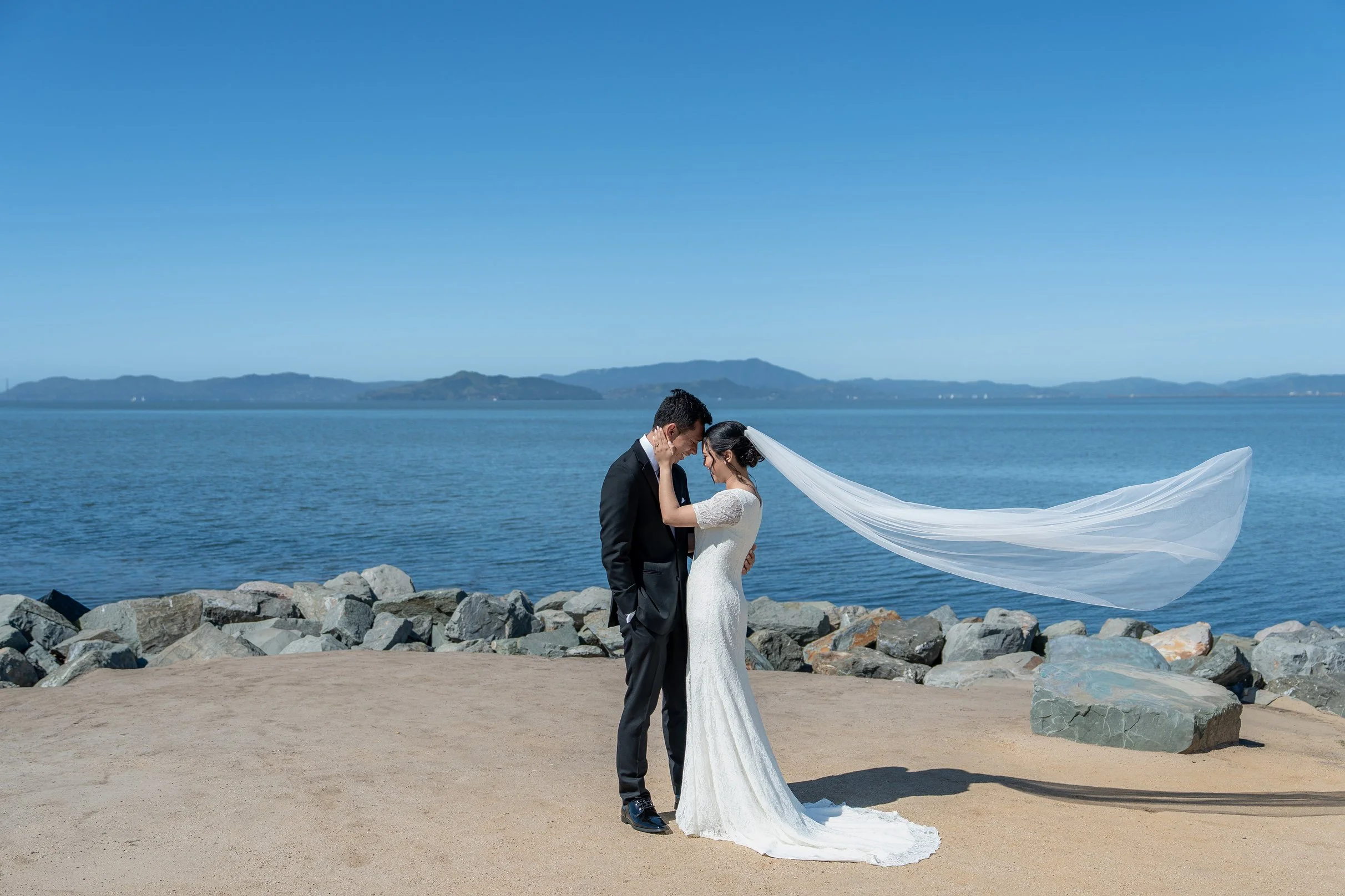 The bride and groom pose calmly for their San Francisco Bay Area wedding photos.
