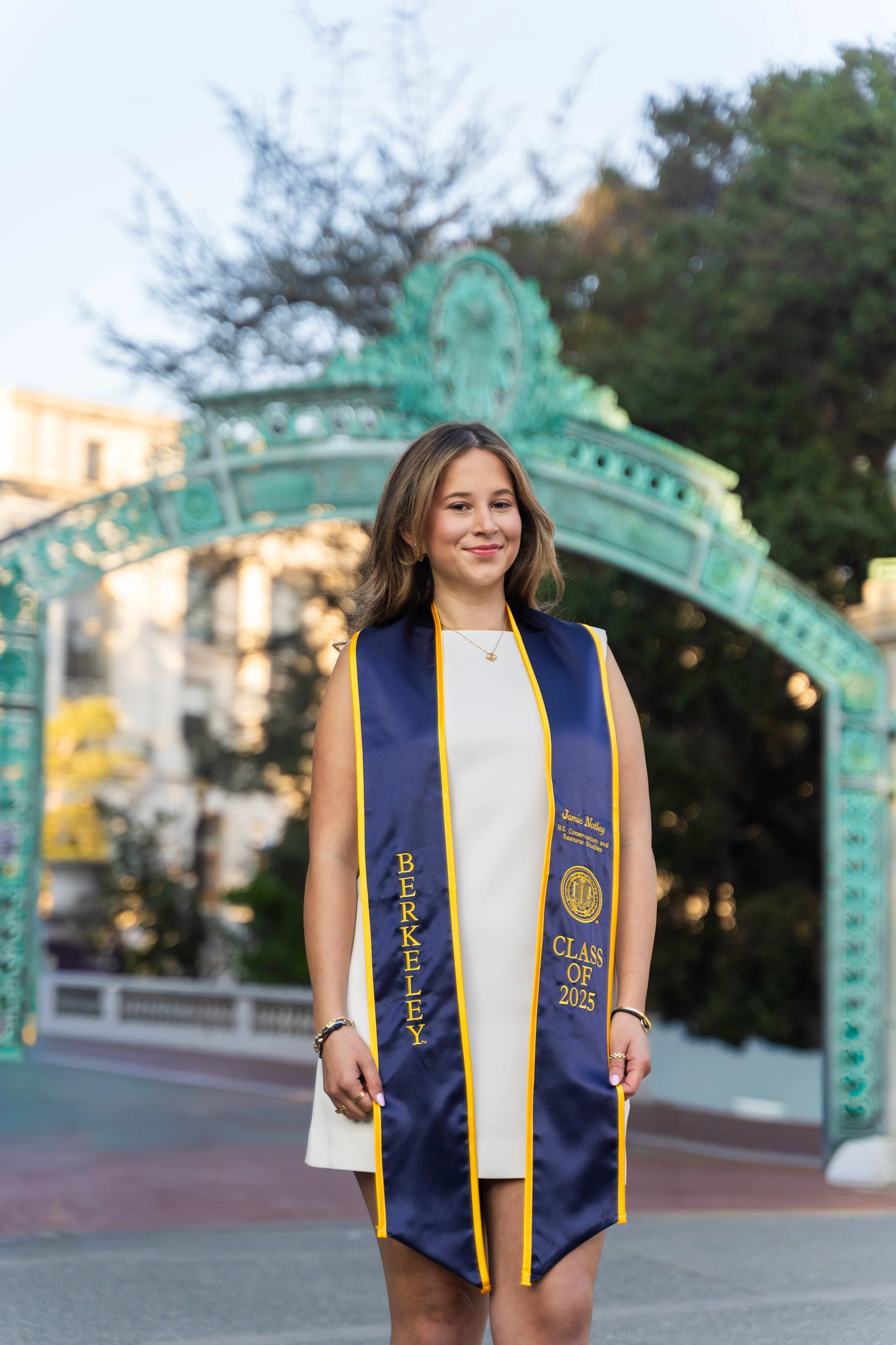 UC-Berkeley-grad-poses-for-photo-by-Sather-Gate
